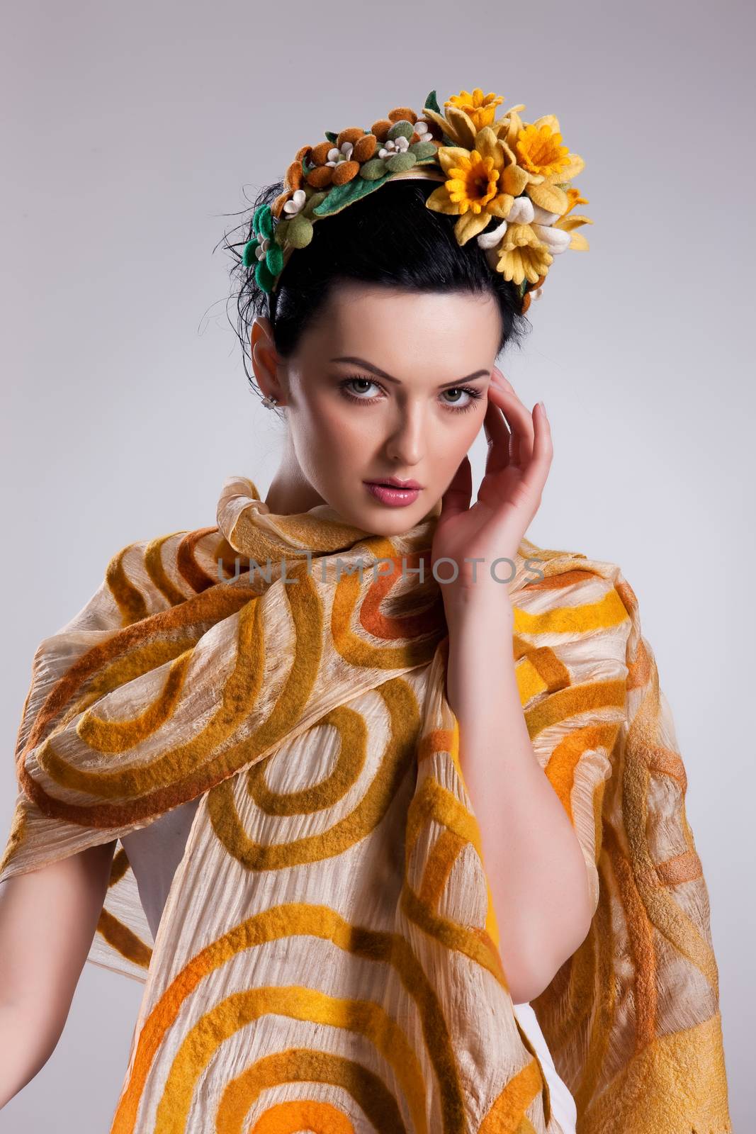 Young attractive woman dressed in handmade clothing on isolated background
