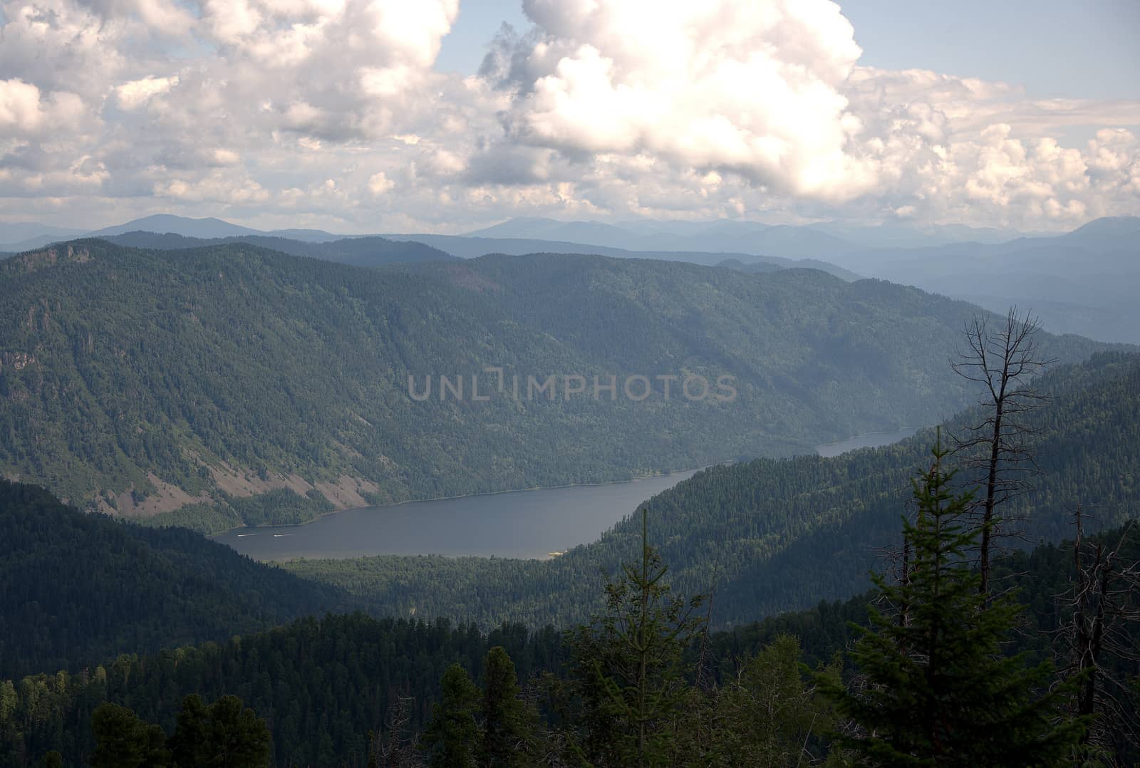 Beautiful view of the valley with a mountain lake from the top of the hill. Altai, Siberia, Russia.