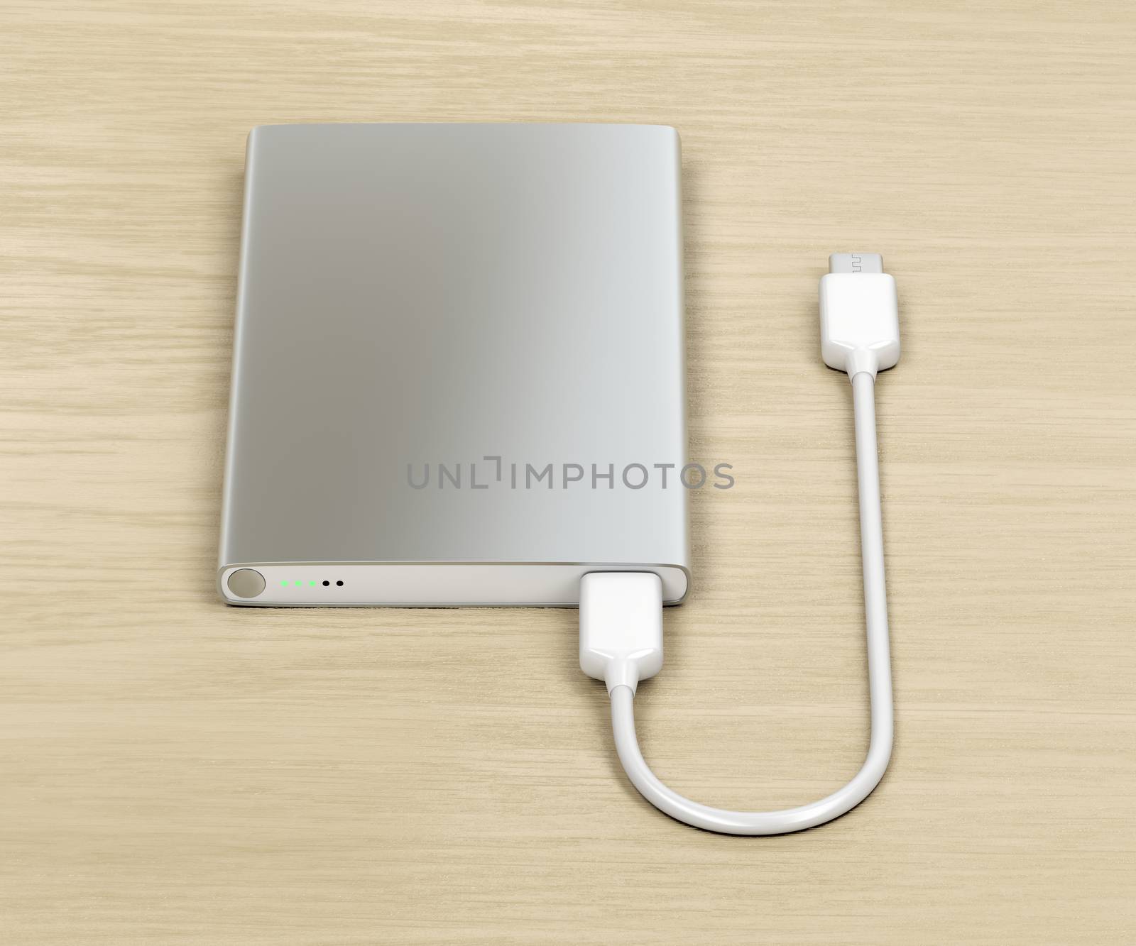 Silver power bank with usb-c cable on wood table