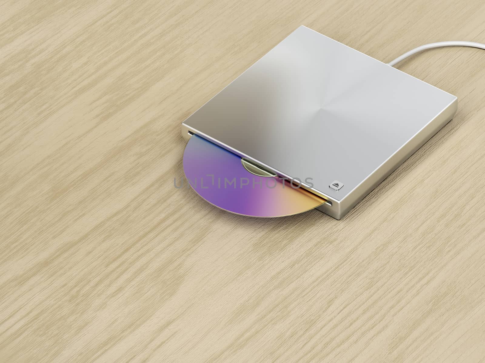 Silver optical disc drive on wood background