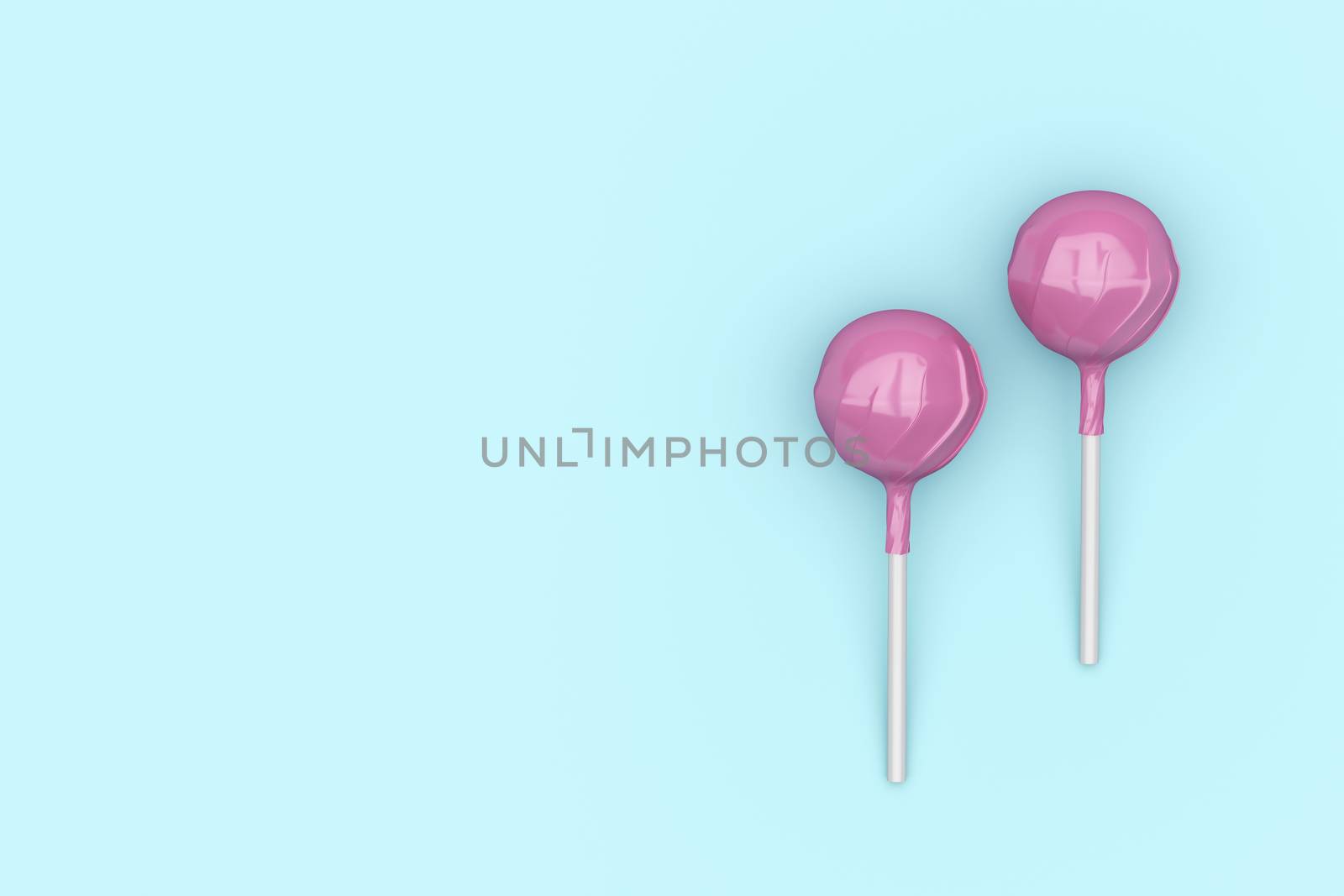 Top view of two pink lollipops on turquoise background