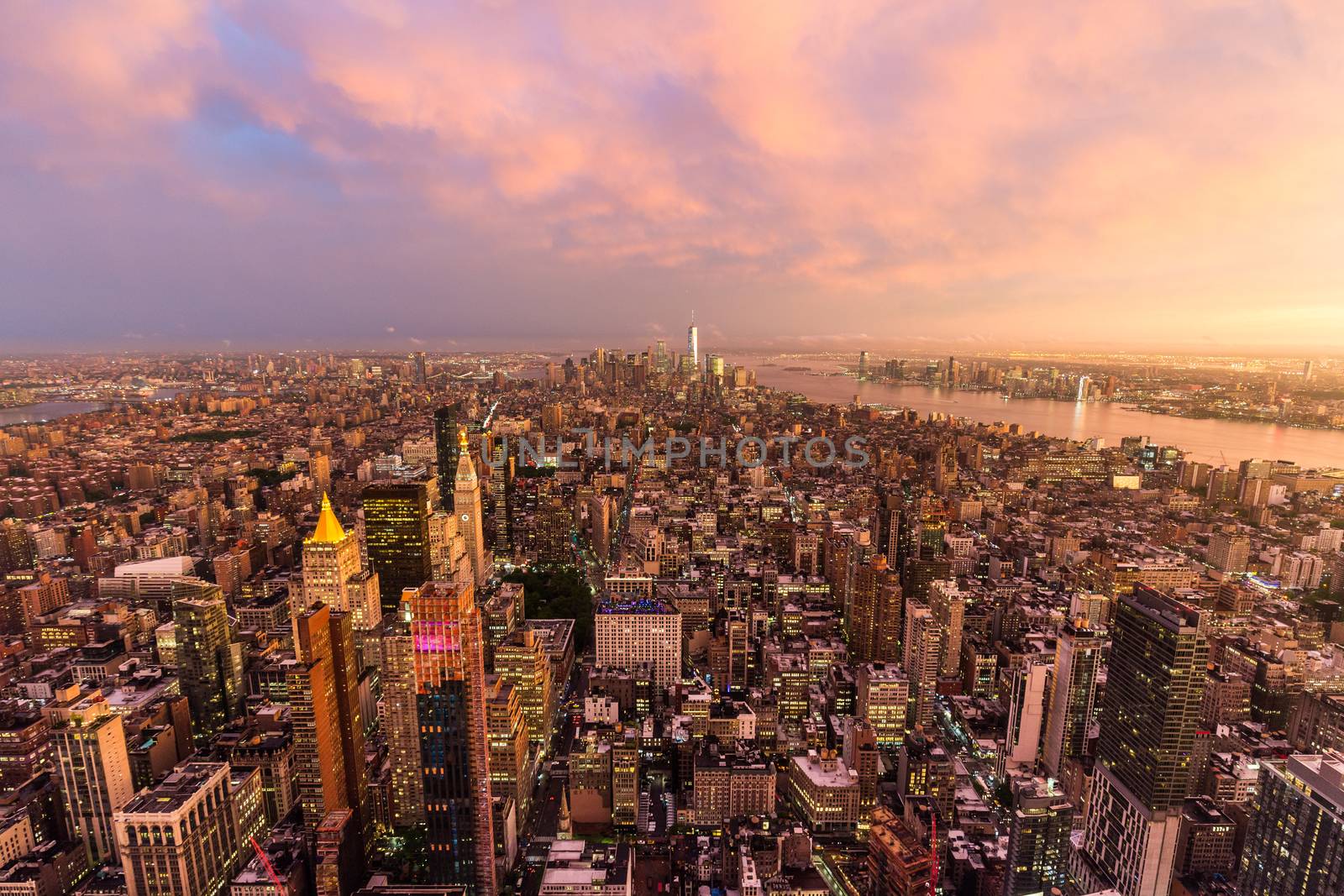 New York City skyline with Manhattan skyscrapers at dramatic vibrant after the storm sunset, USA. Rainbow and lightnings can be seen in background over Brooklyn bridge.