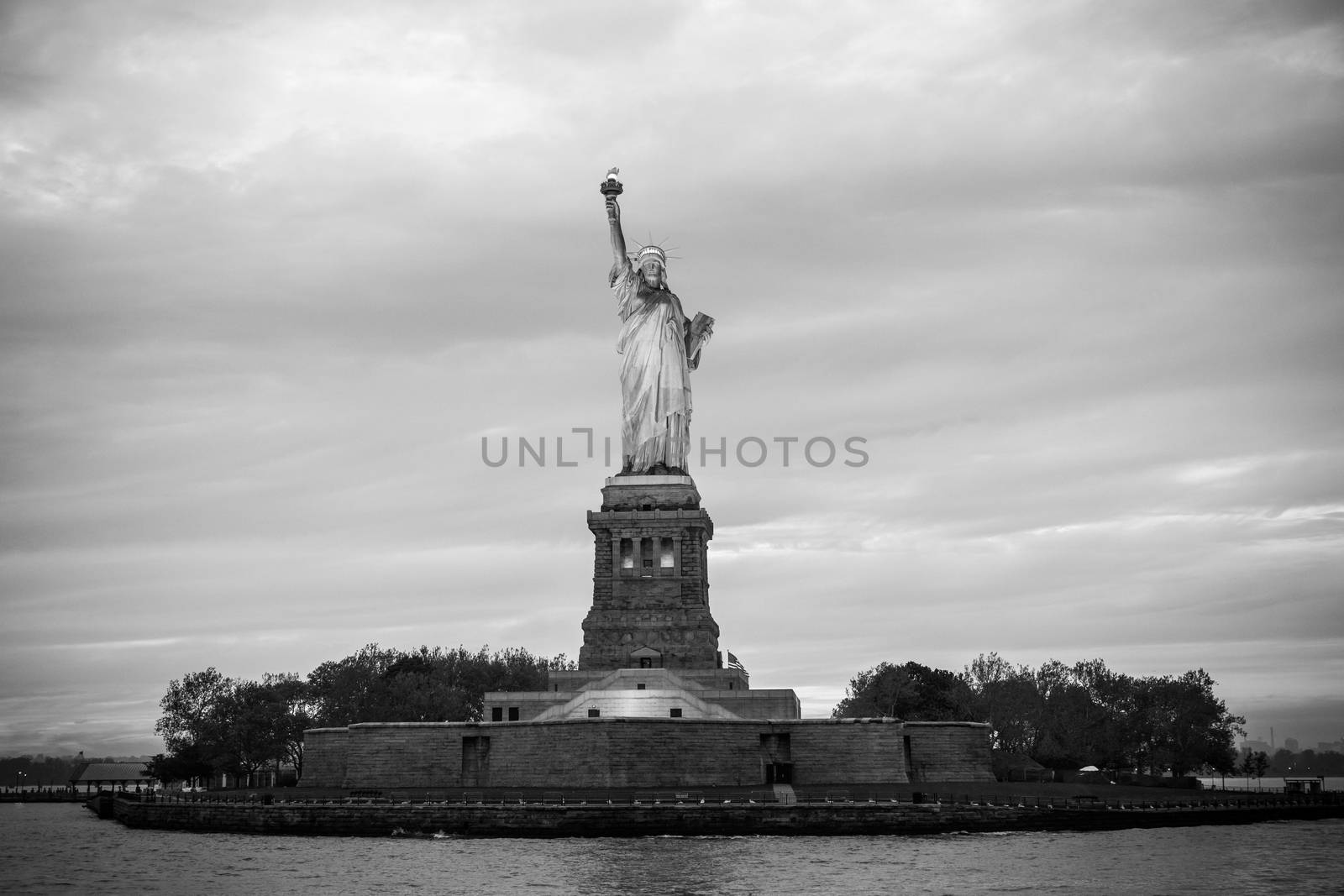 Statue of Liberty at dusk, New York City, USA. Black and white image.