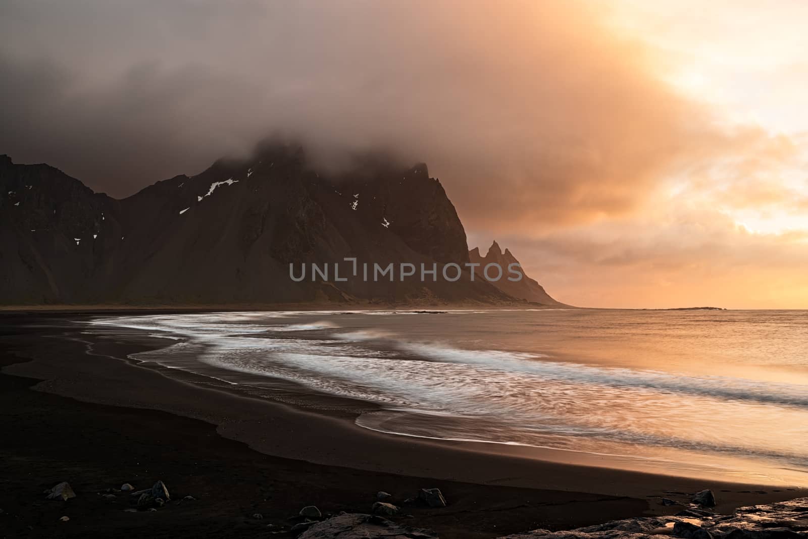 Vestrahorn mountain and the black beach at sunrise in a cloudy day, Iceland