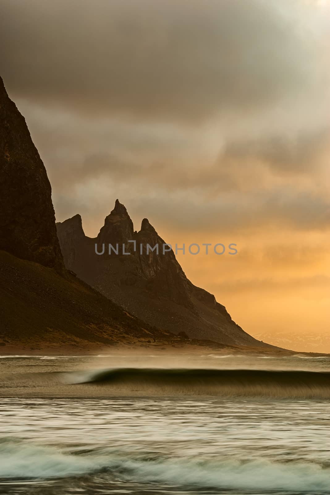 Vestrahorn mountain and ocean at sunrise in a cloudy day, Iceland