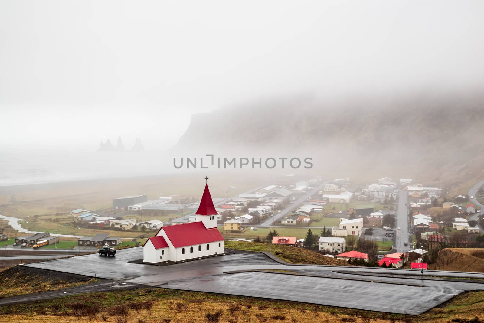 Church in Vik i Myrdal in a foggy day seen from the hill, Iceland