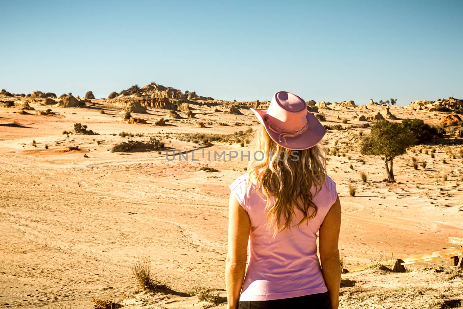 Female tourist visitor looking out to the Mungo Lunettes by lovleah