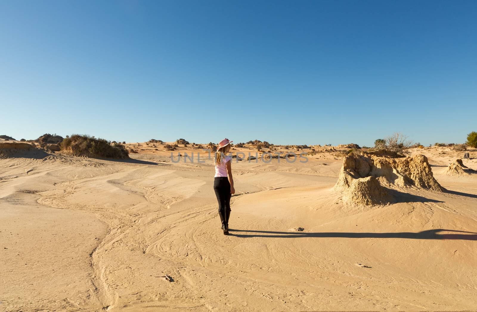 Woman walking in a desert landscape in outback Australia