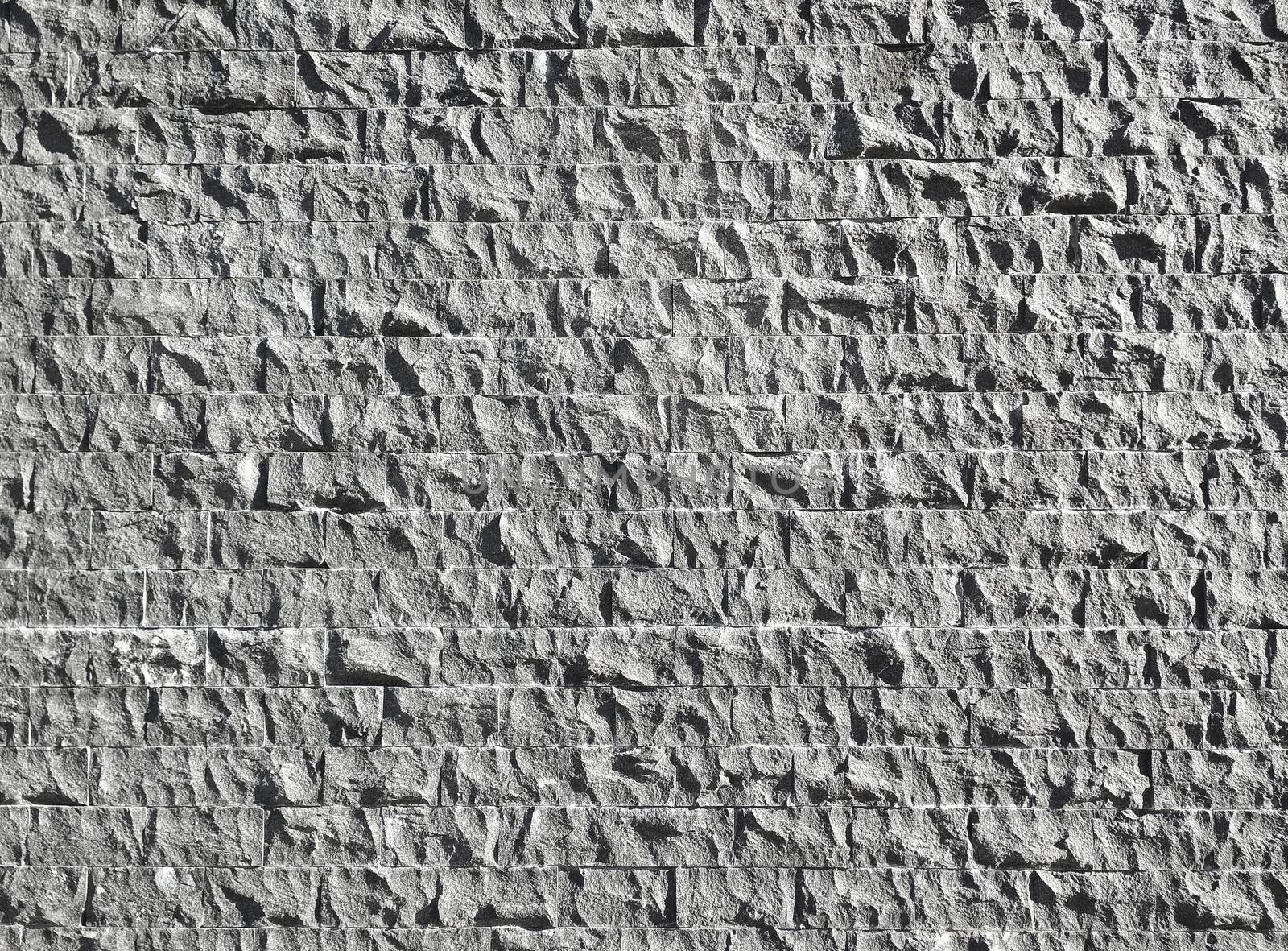 The background of several rows of granite blocks is gray.