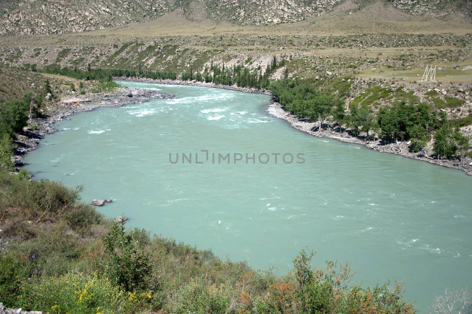 A turquoise river flowing between mountains and a picturesque valley. Katun, Altai, Russia.