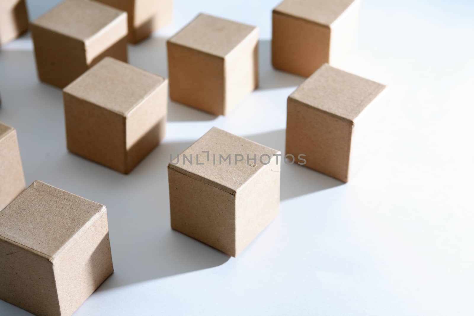 Set of cardboard cubes on white background with light and shadows