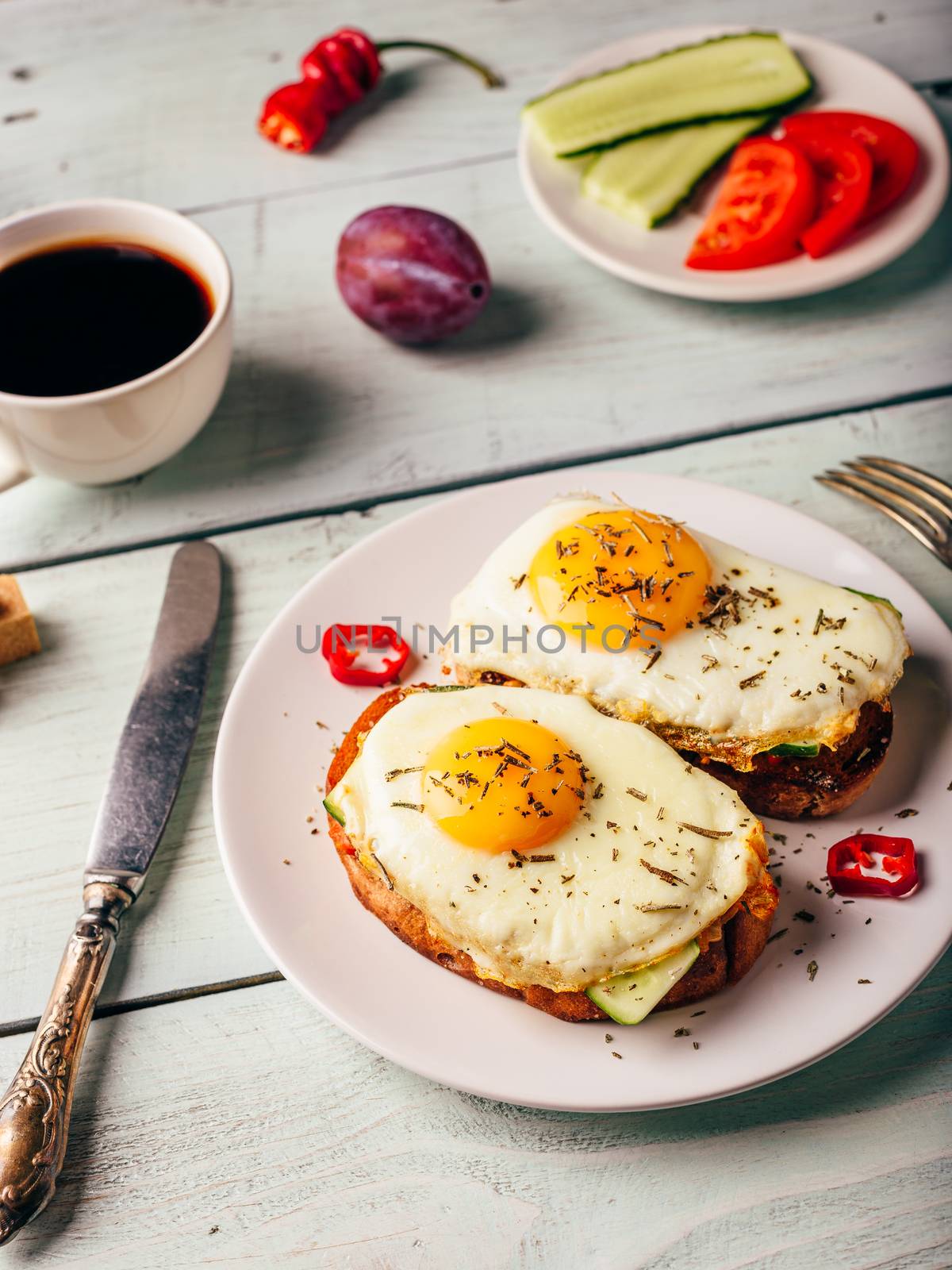 Toasts with vegetables and fried egg and cup of coffee by Seva_blsv