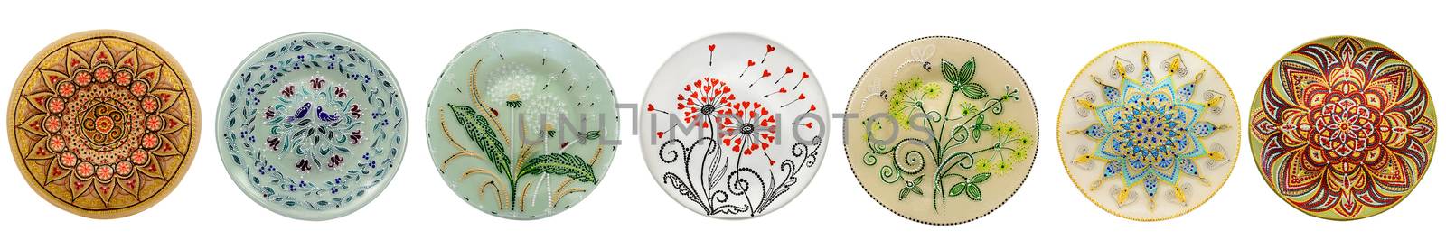 Set of decorative ceramic dishes hand-painted with acrylic paints floral pattern isolated on white background.