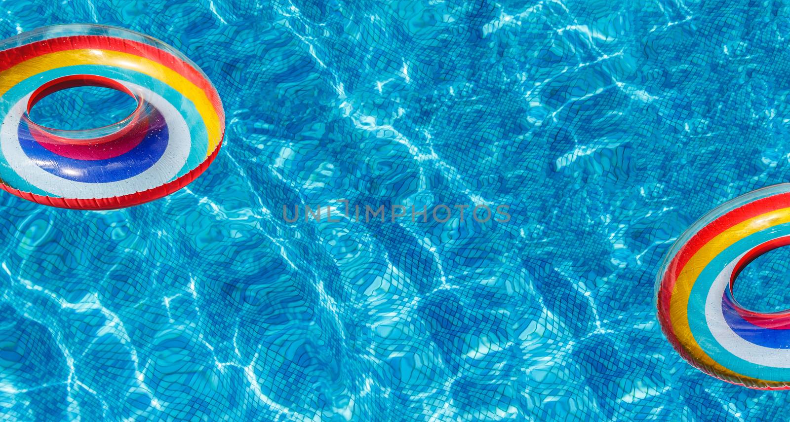 Inflatable water activities two circles tuba float on the water in the pool. banner.Concept, fun, perky summer and relaxation. by Tanacha