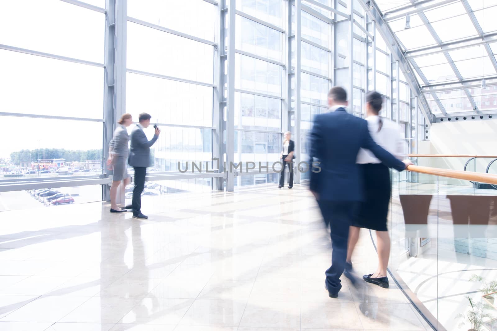 Business people walking in a modern hall of office building