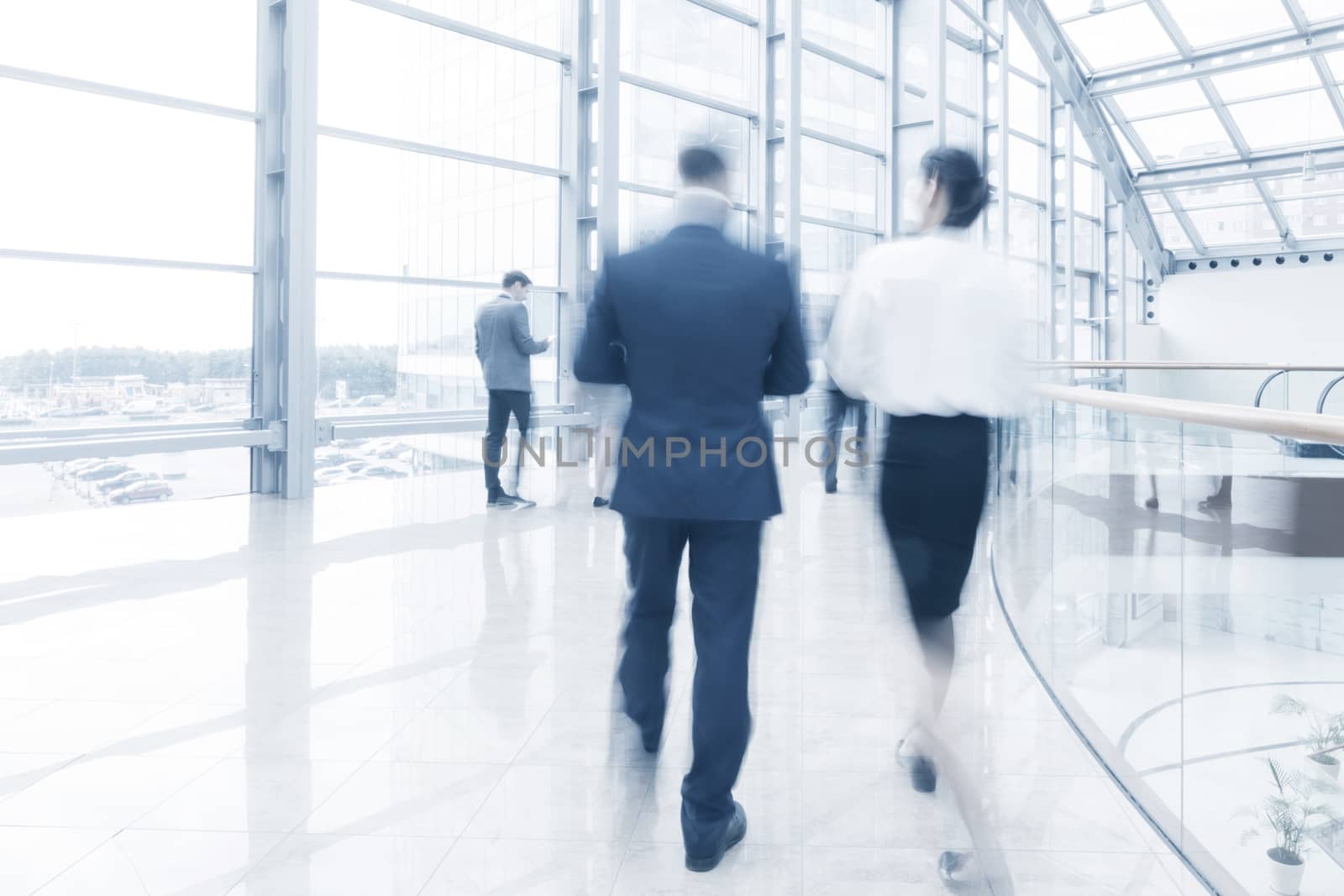 Business people walking in a modern hall of office building