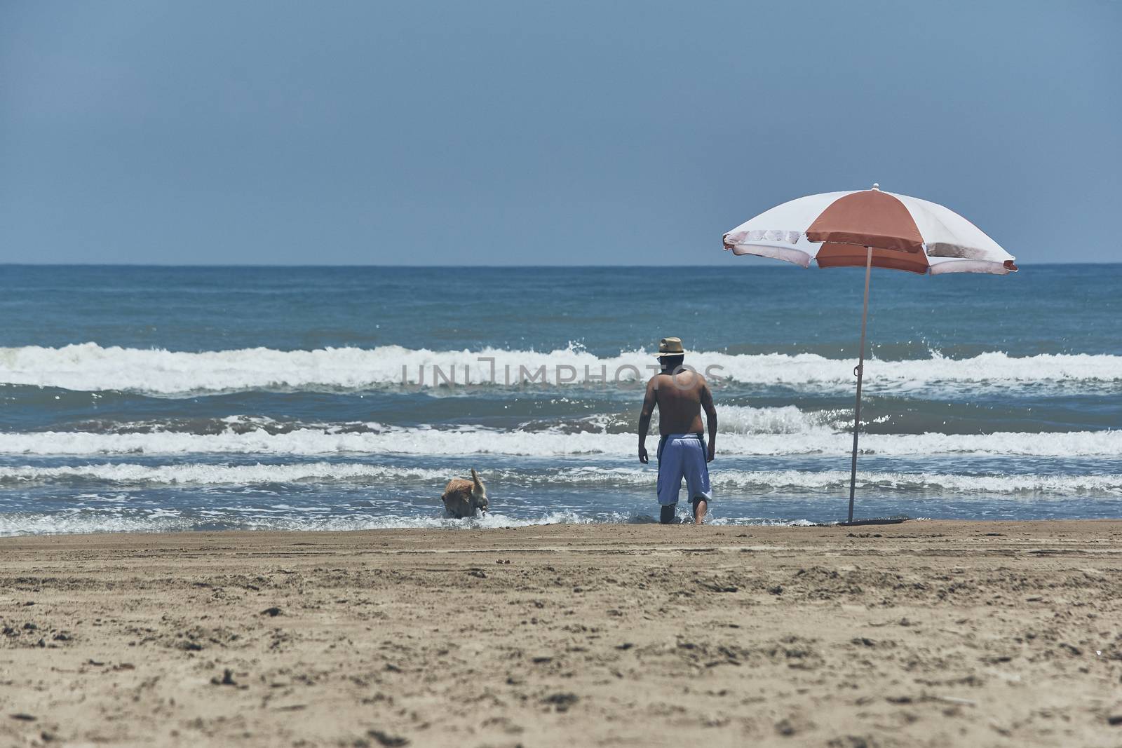 Woman Standing on the beach admiring the ocean in front of her