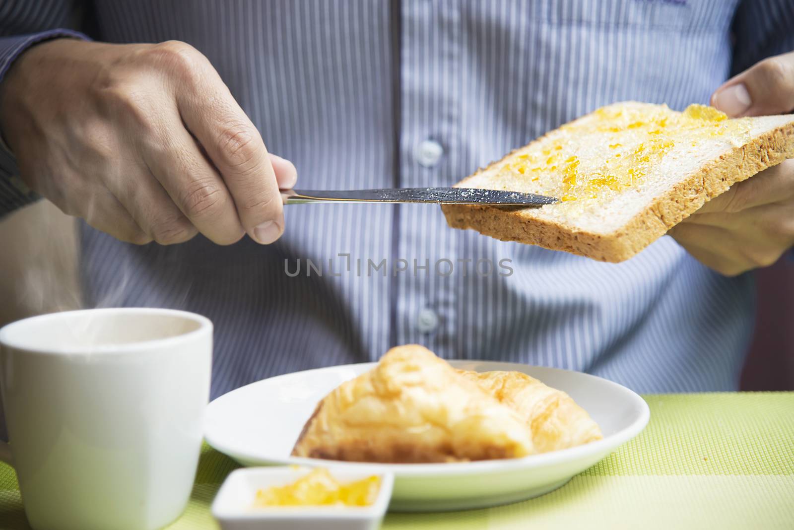 Business man eat the American breakfast set in a hotel - people take a breakfast in hotel concept by pairhandmade