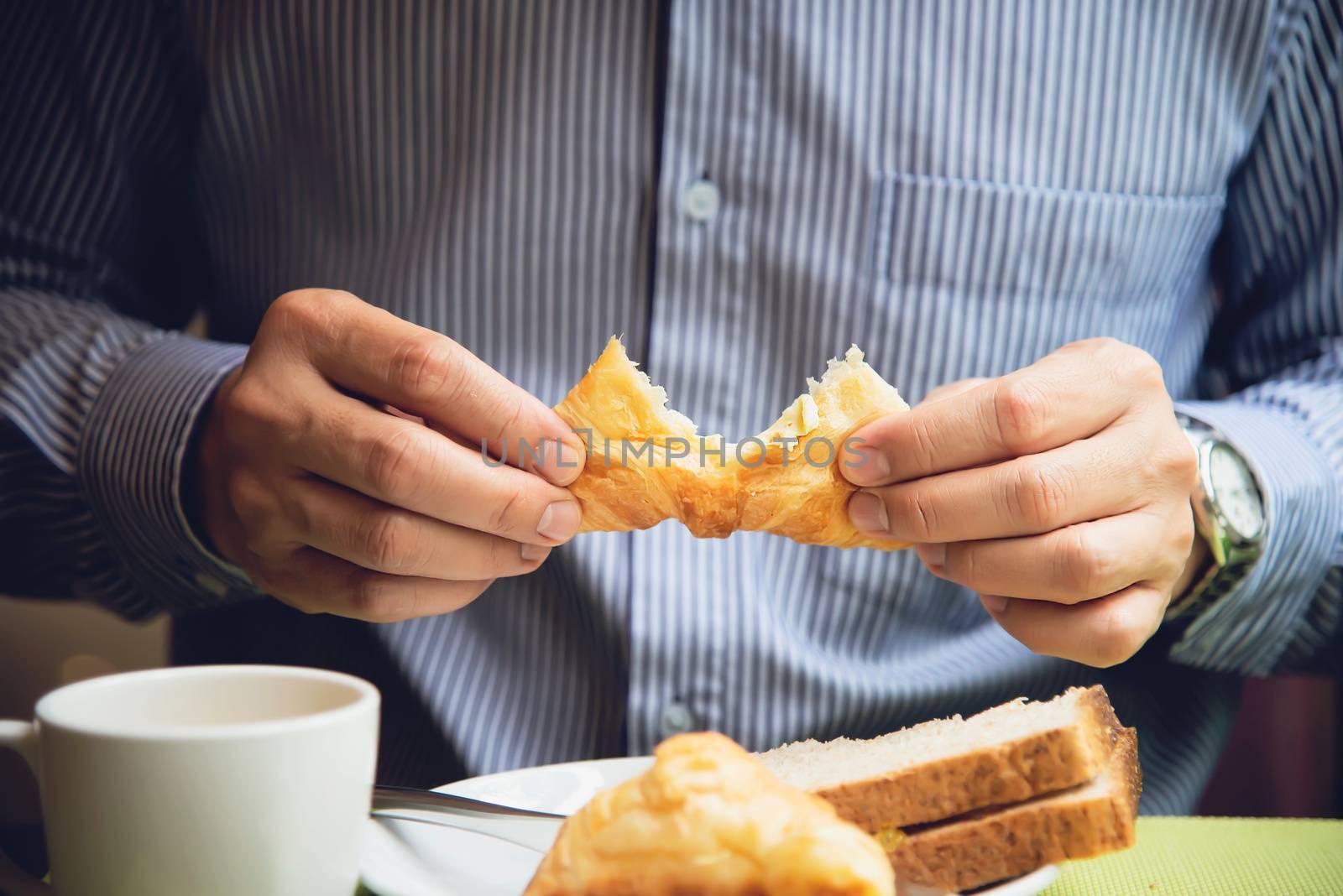 Business man eat the American breakfast set in a hotel - people take a breakfast in hotel concept