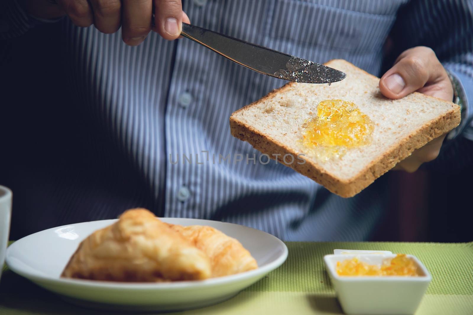 Business man eat the American breakfast set in a hotel - people take a breakfast in hotel concept by pairhandmade