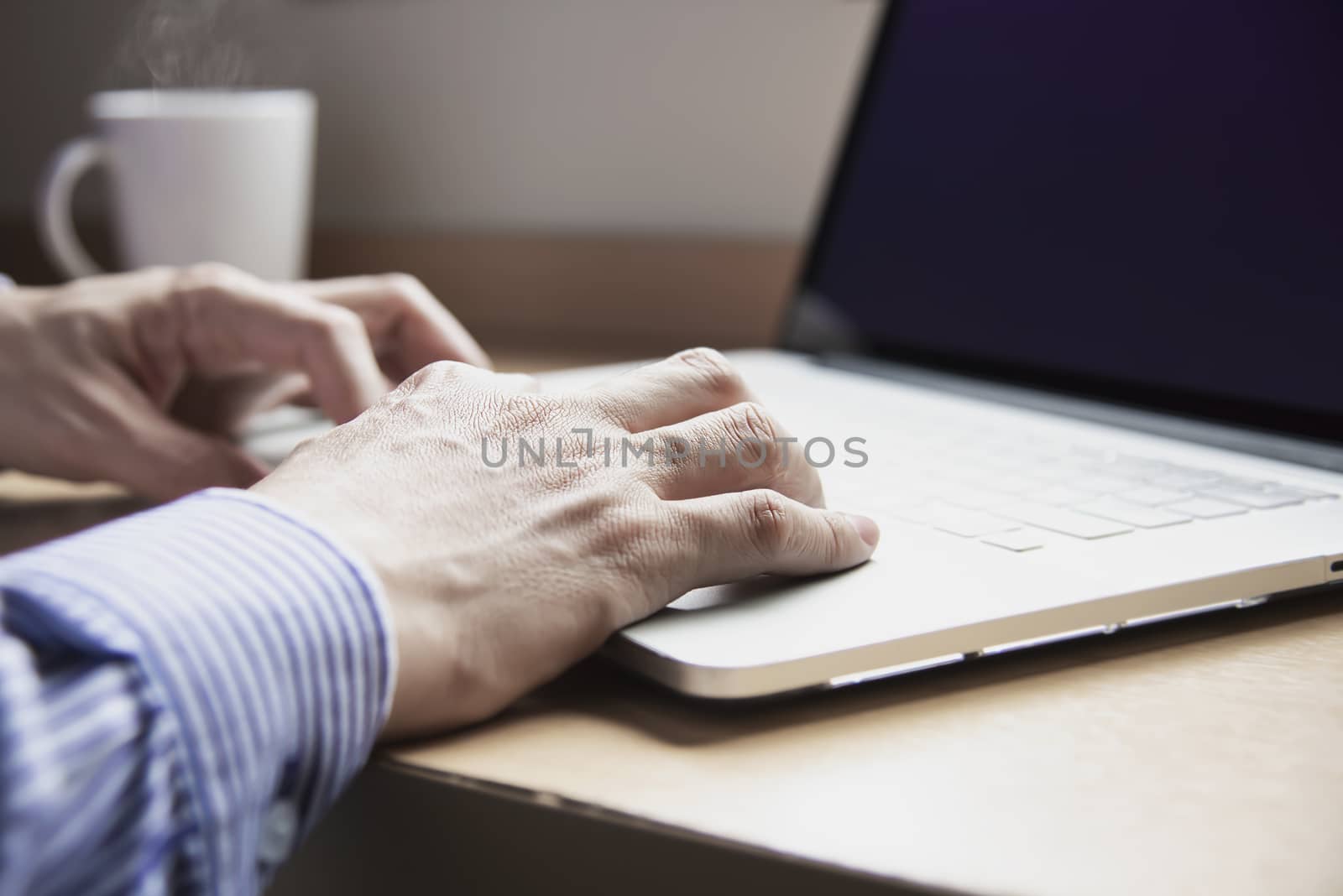 Businessman working with computer with coffee cup in the hotel room - people working lifestyle concept