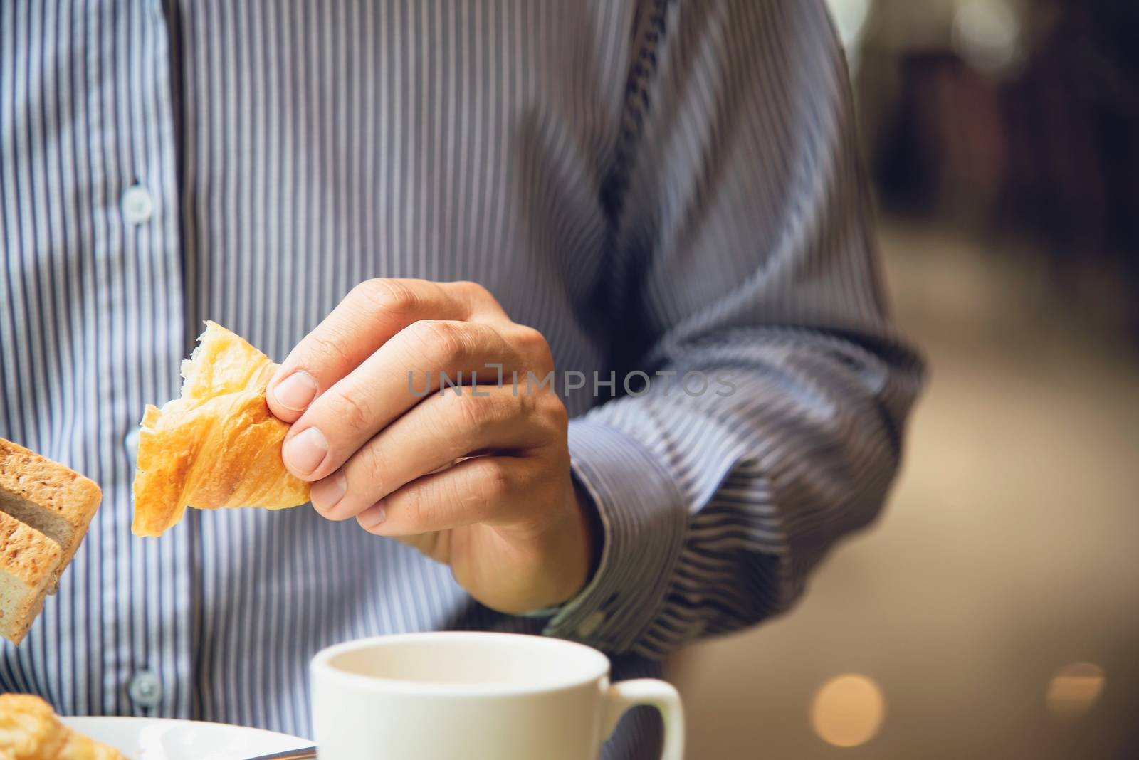 Business man eat the American breakfast set in a hotel - people take a breakfast in hotel concept