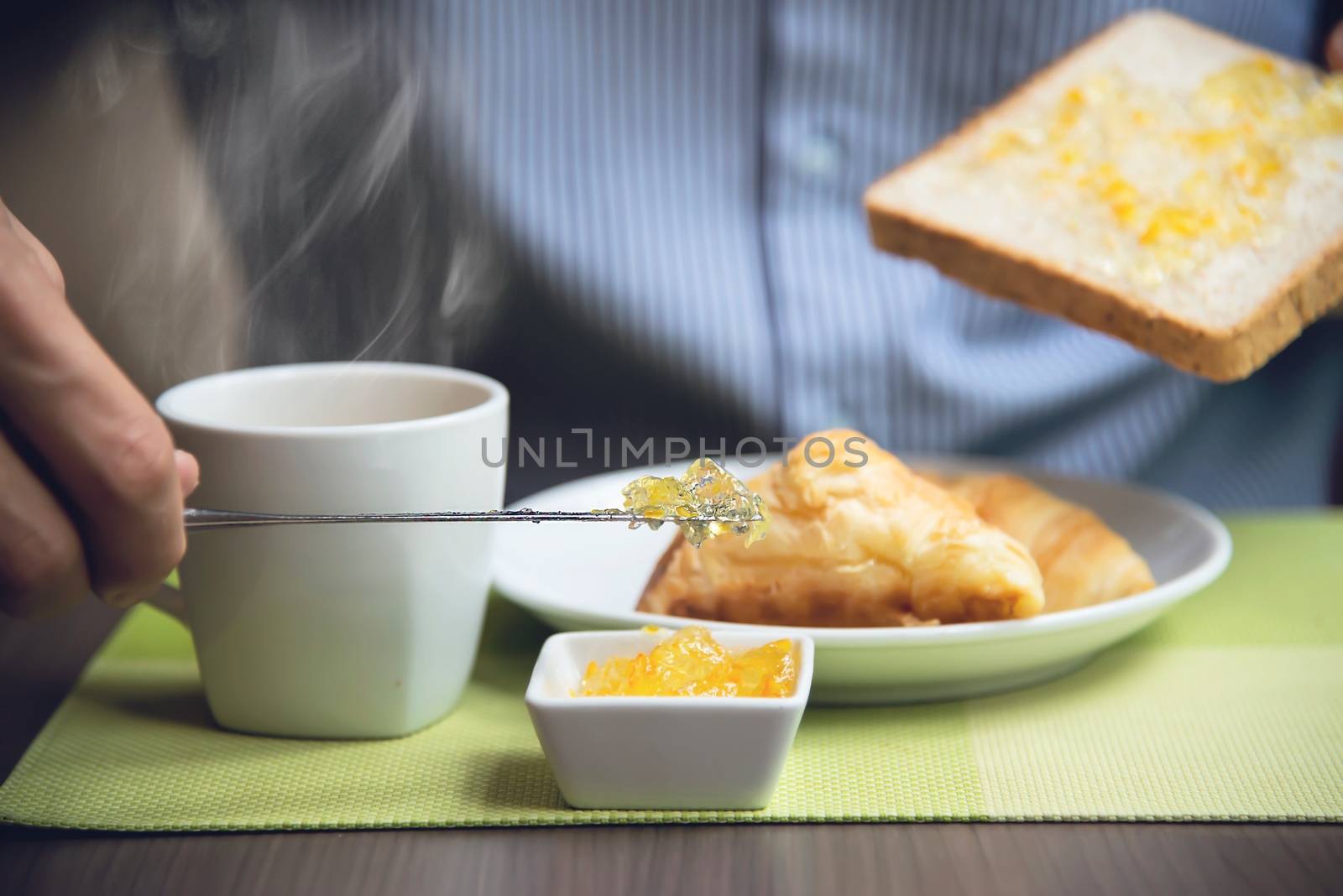 Business man eat the American breakfast set in a hotel - people take a breakfast in hotel concept by pairhandmade