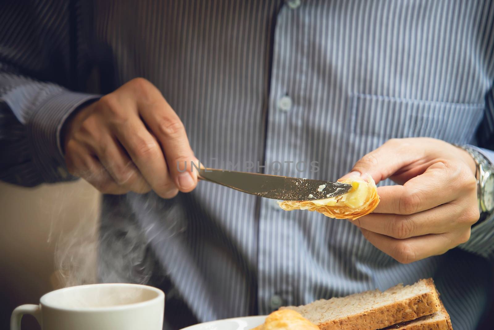 Business man eat the American breakfast set in a hotel - people take a breakfast in hotel concept by pairhandmade