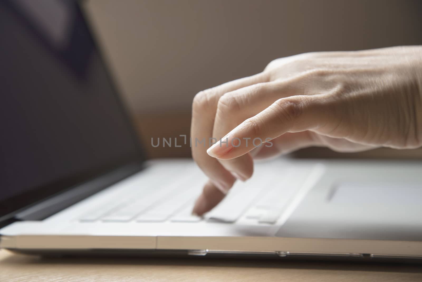 Lady finger touch or press laptop keyboard  - people working with technology concept