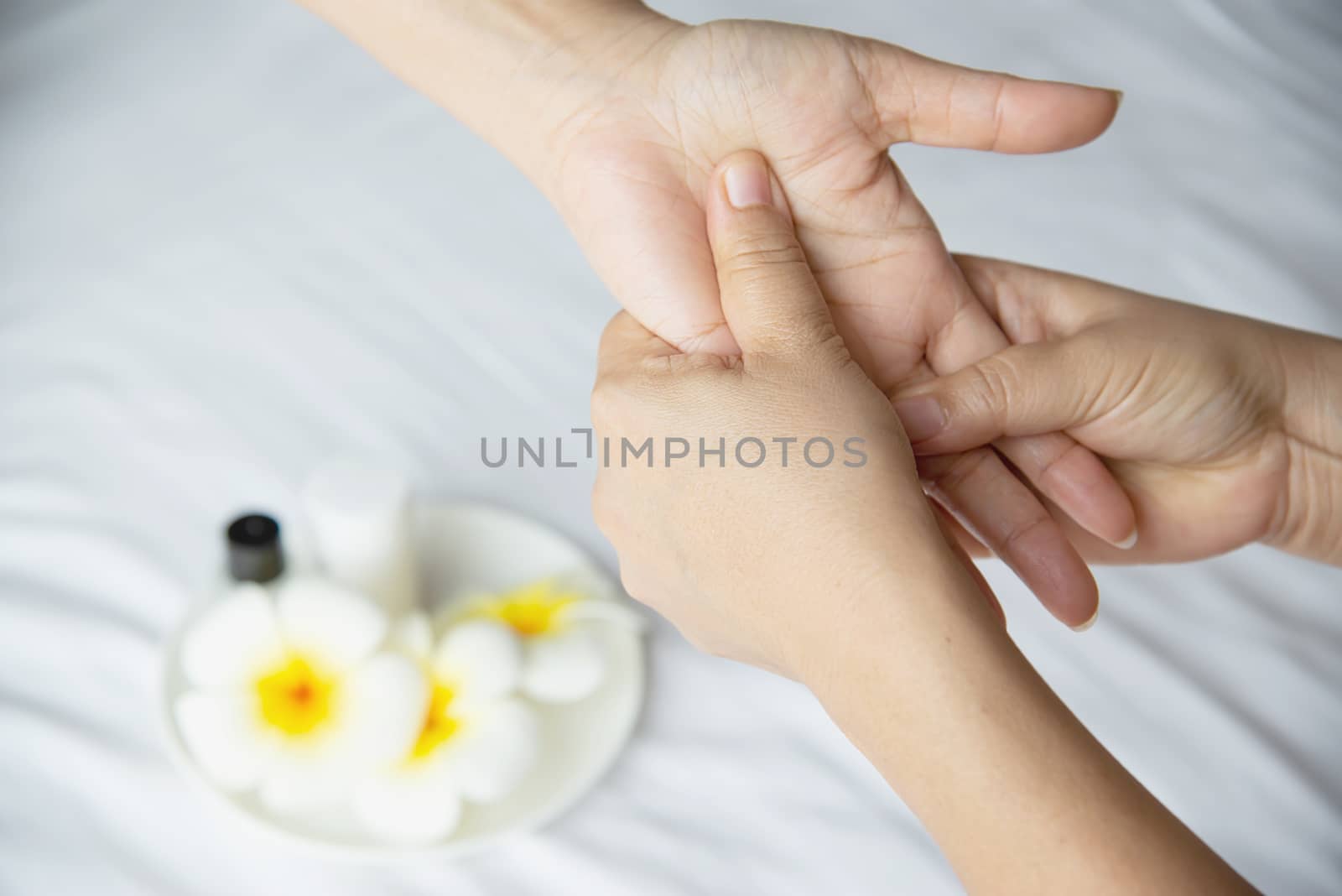 Hand spa massage over clean white bed background - people relax with hand massage service