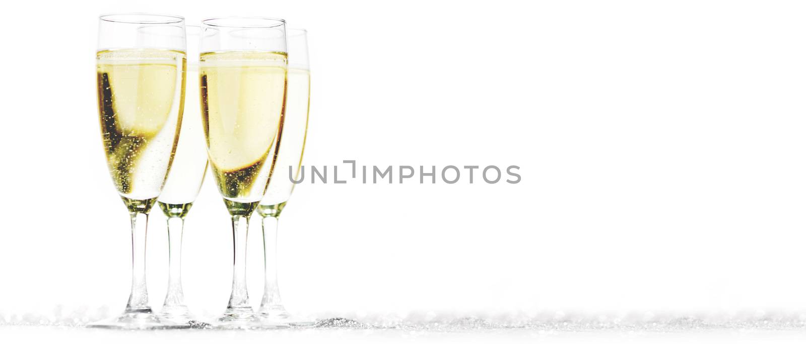 Champagne flutes on shiny glitter background