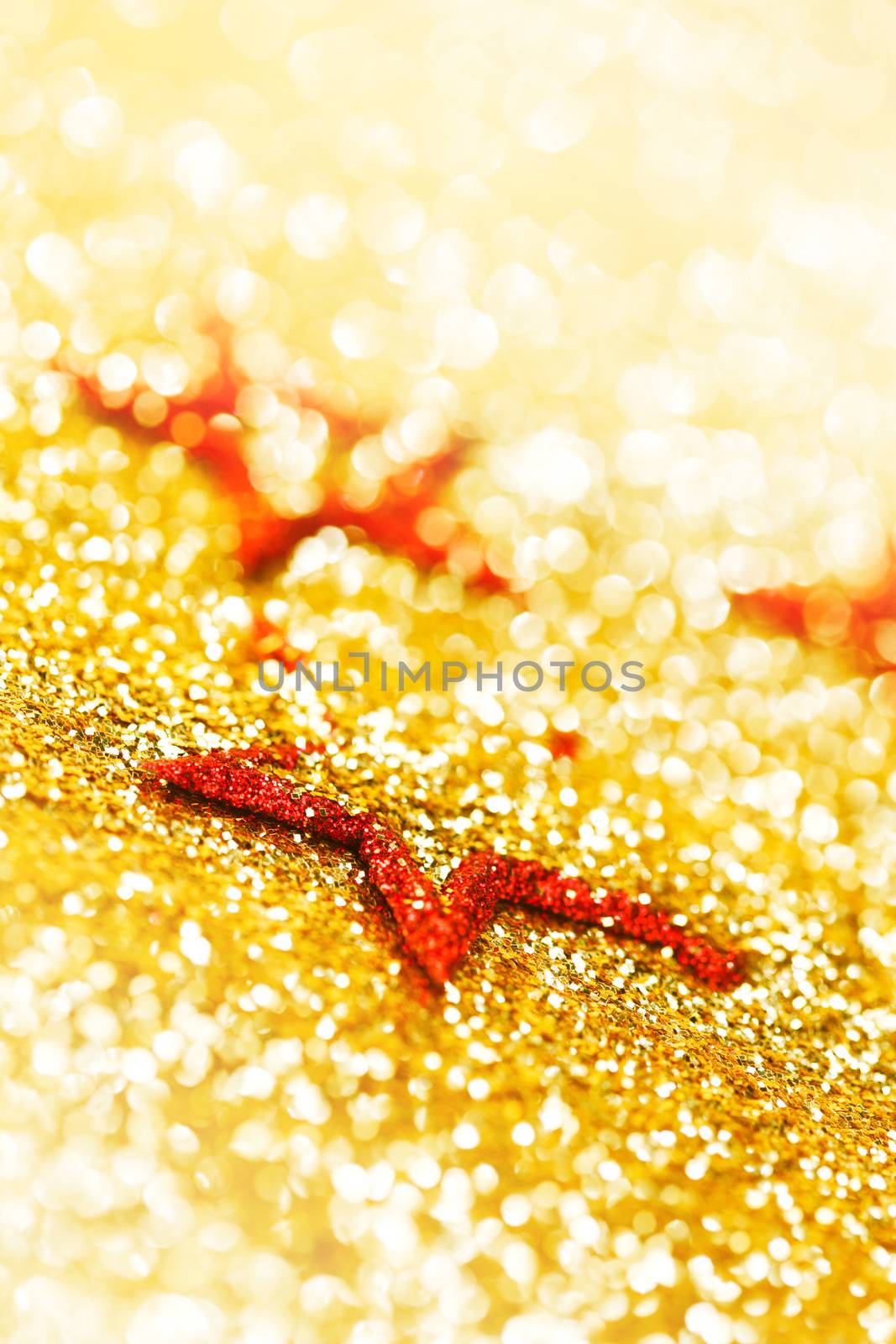 Christmas decorative red stars on shiny glitters background