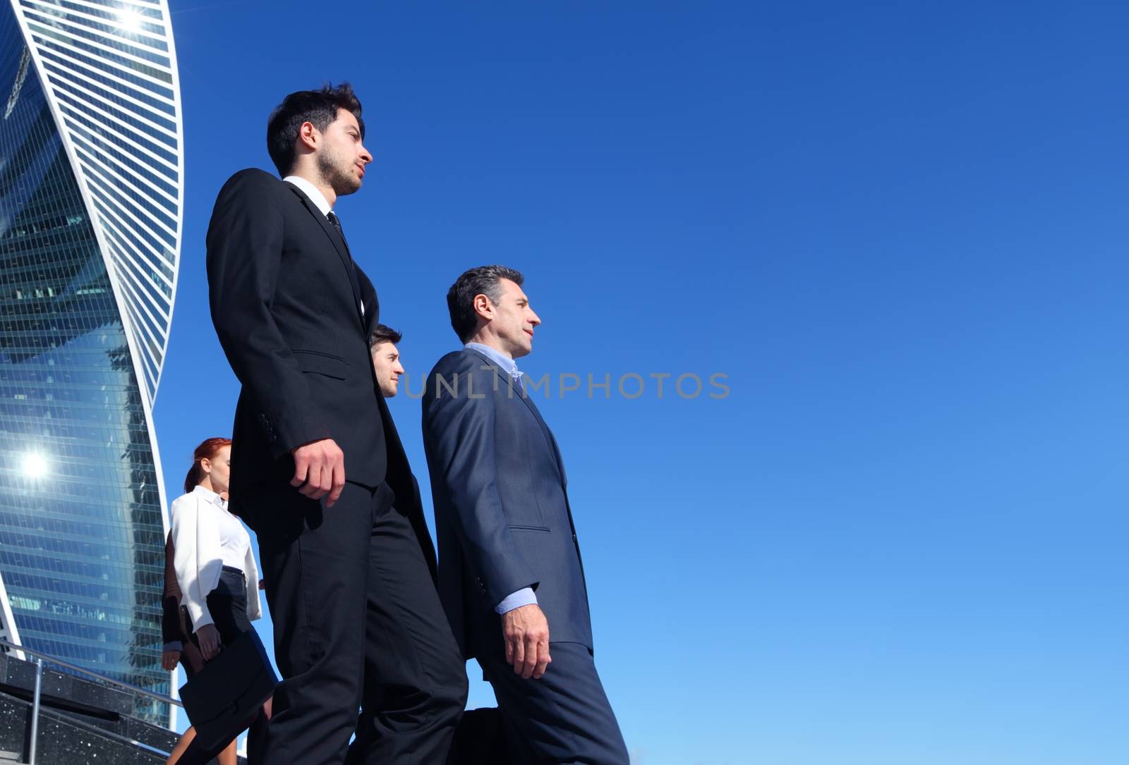 Team of diverse business people outdoors of company office building