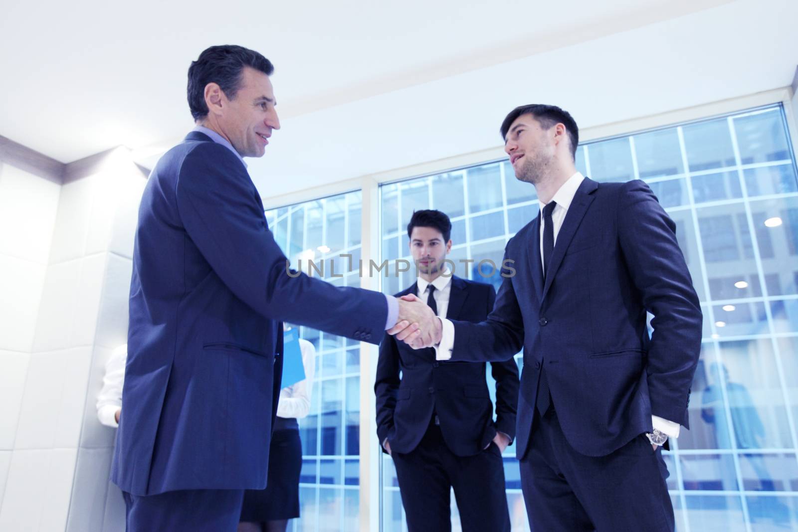 Business people shaking hands, finishing up a meeting in office