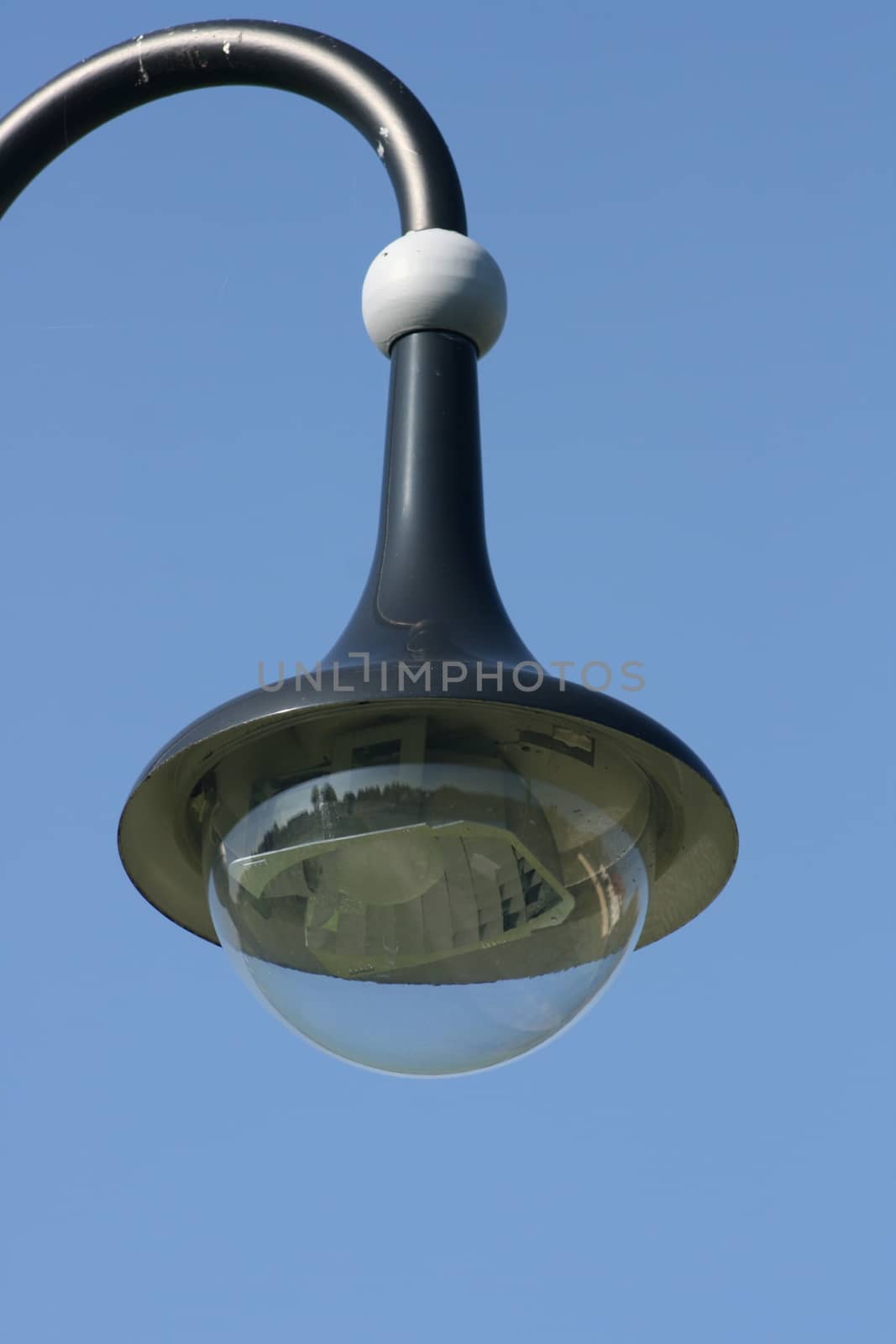 Street lamp with a large screen, blue sky in the background  Strassenlaterne mit gro�em Schirm,blauer Himmel im Hintergrund