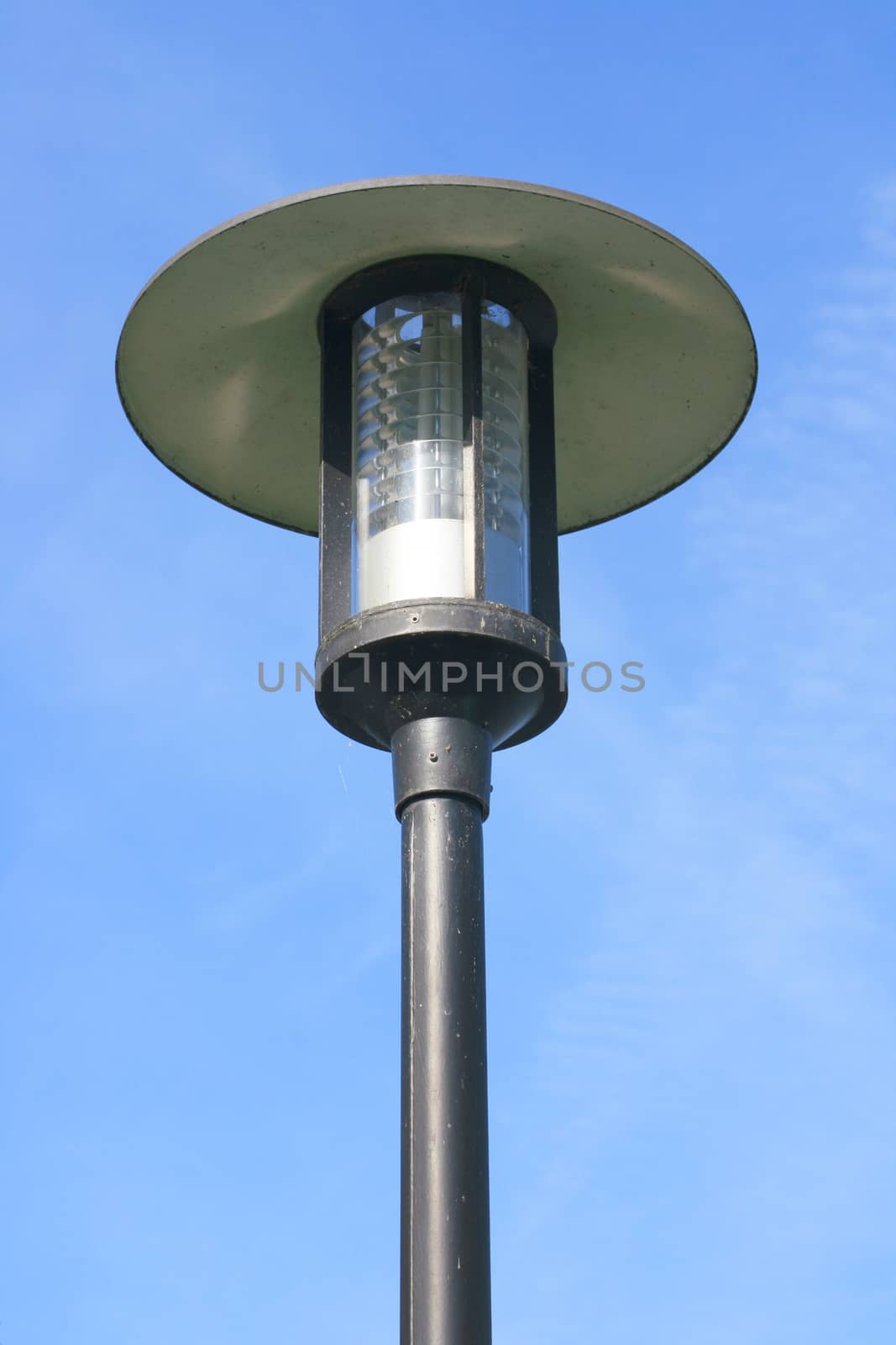 Street lamp with a large screen, blue sky in the background  Strassenlaterne mit gro�em Schirm,blauer Himmel im Hintergrund