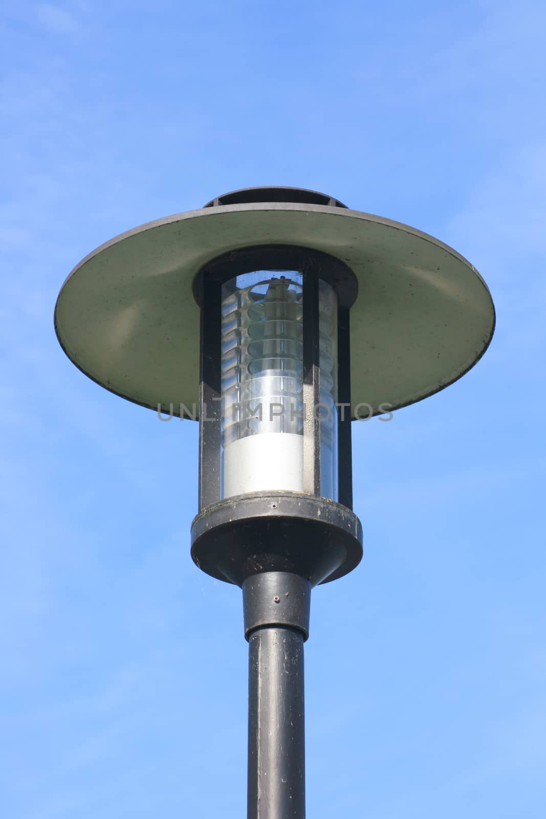 Street lamp with a large screen, blue sky in the background  Strassenlaterne mit gro�em Schirm,blauer Himmel im Hintergrund