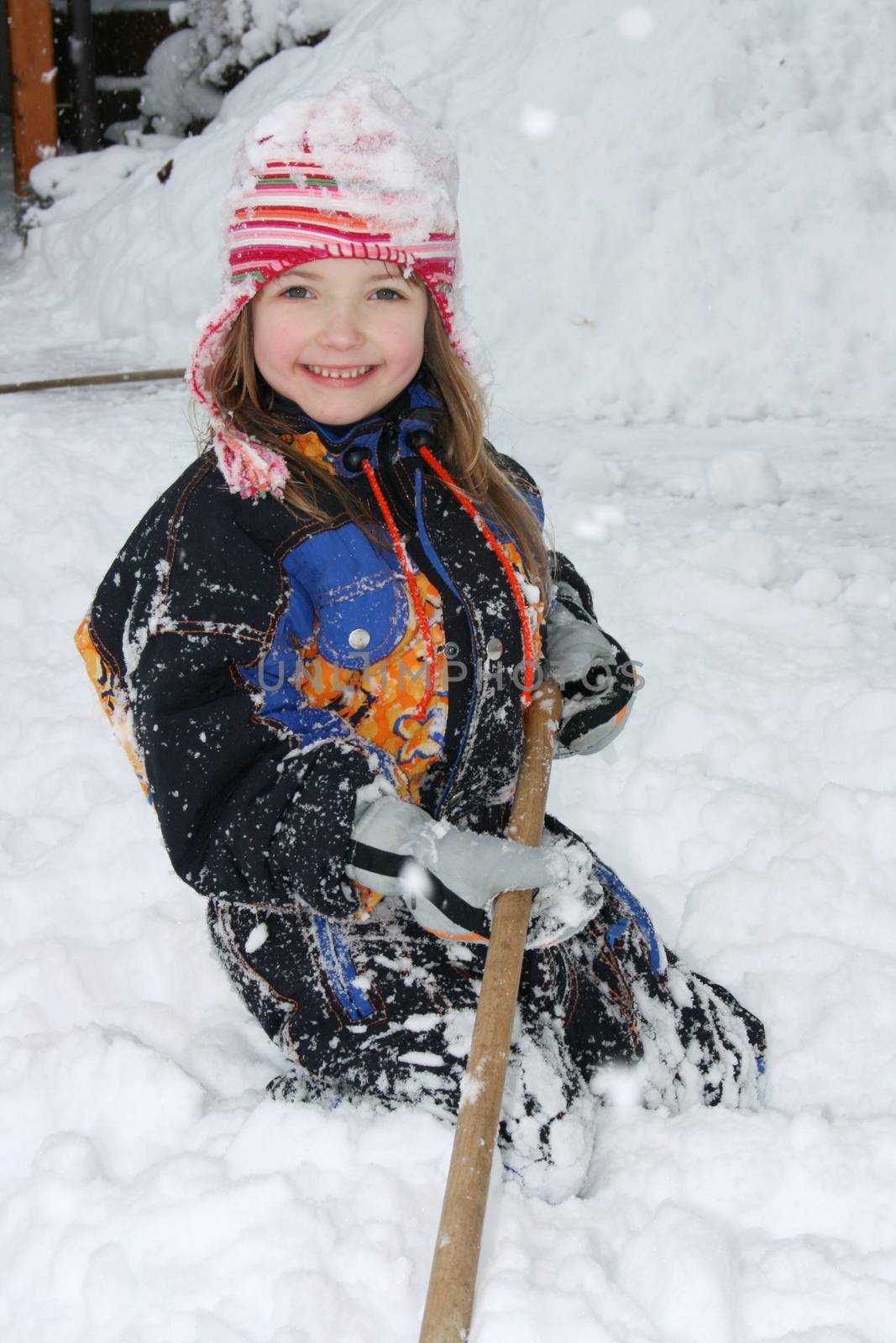 A blonde girl has fun in the snow