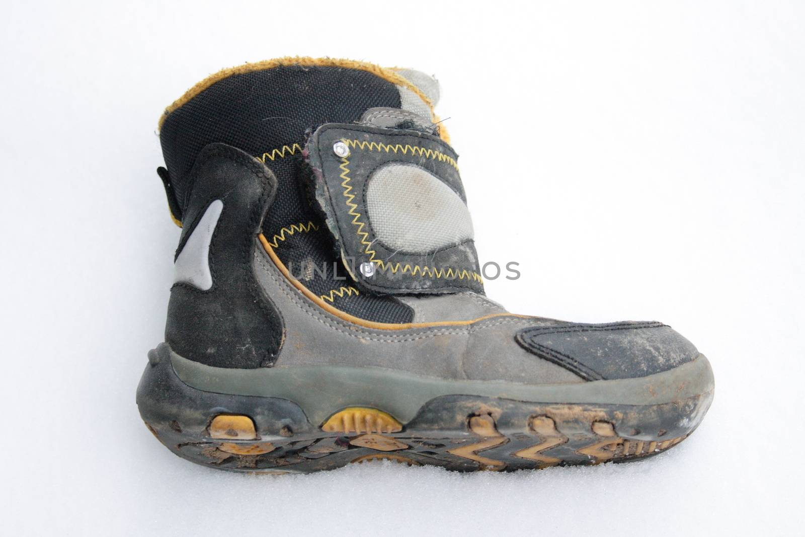 used winter boots lying in the snow by hadot