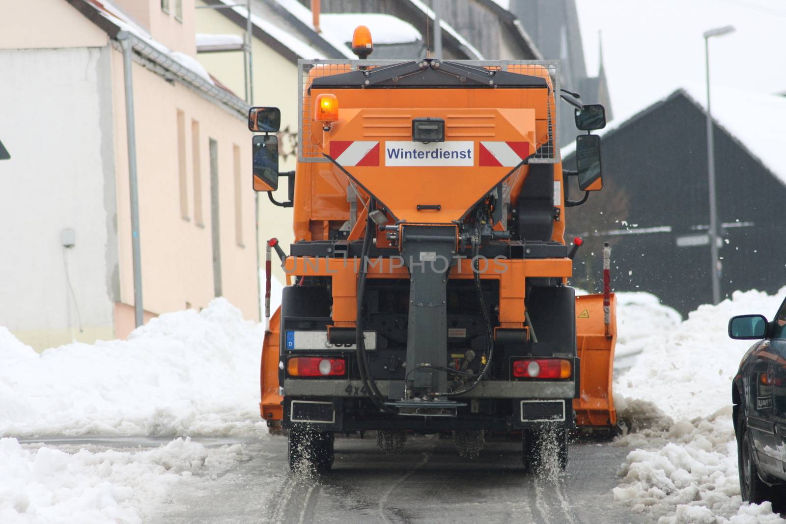 Winter service vehicle in use in heavy snow-fall  Winterdienstfahrzeug im Einsatz bei starkem Schneefall by hadot
