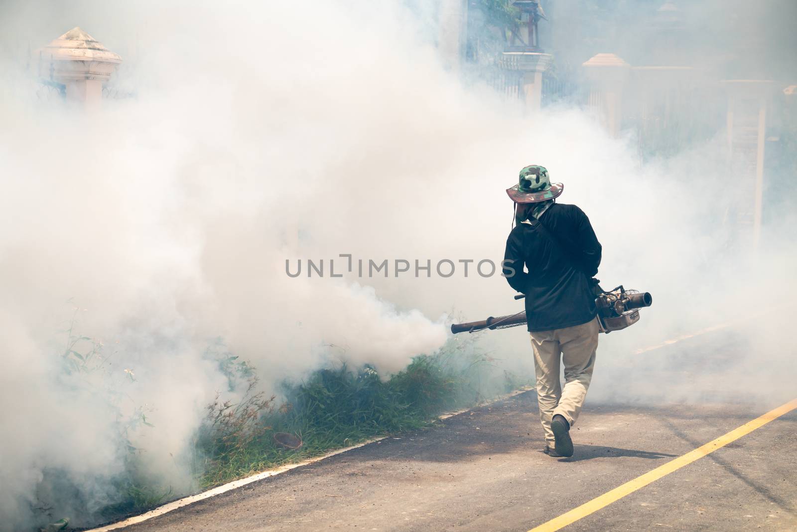 man use fumigation mosquitoes machine for kill mosquito carrier of Zika virus and dengue fever around the house