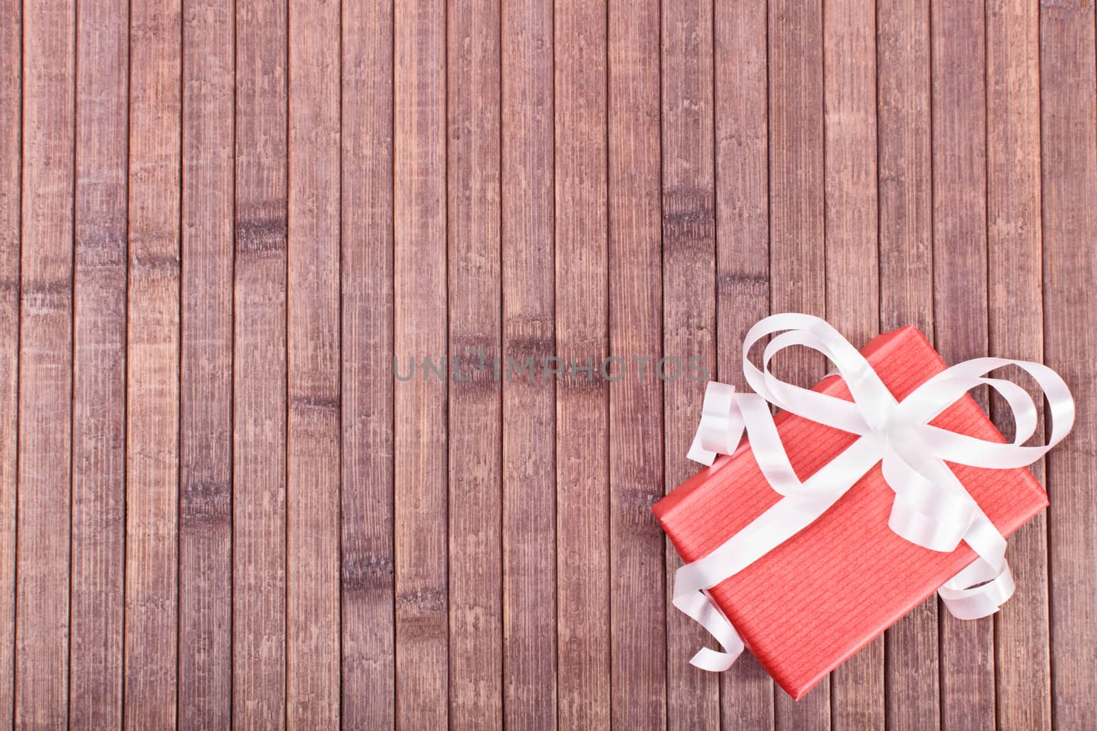 Top view of a gift box on a wooden background.