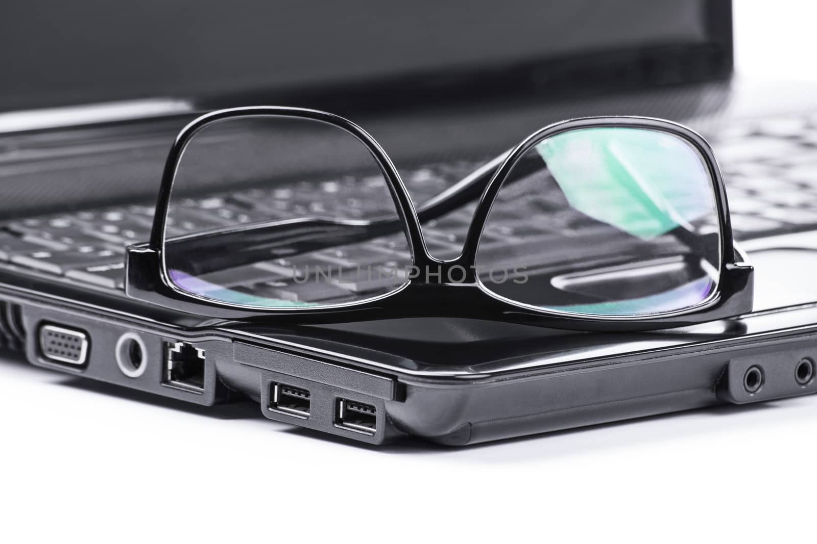 Close up shot of glasses on a laptop, isolated on white background.