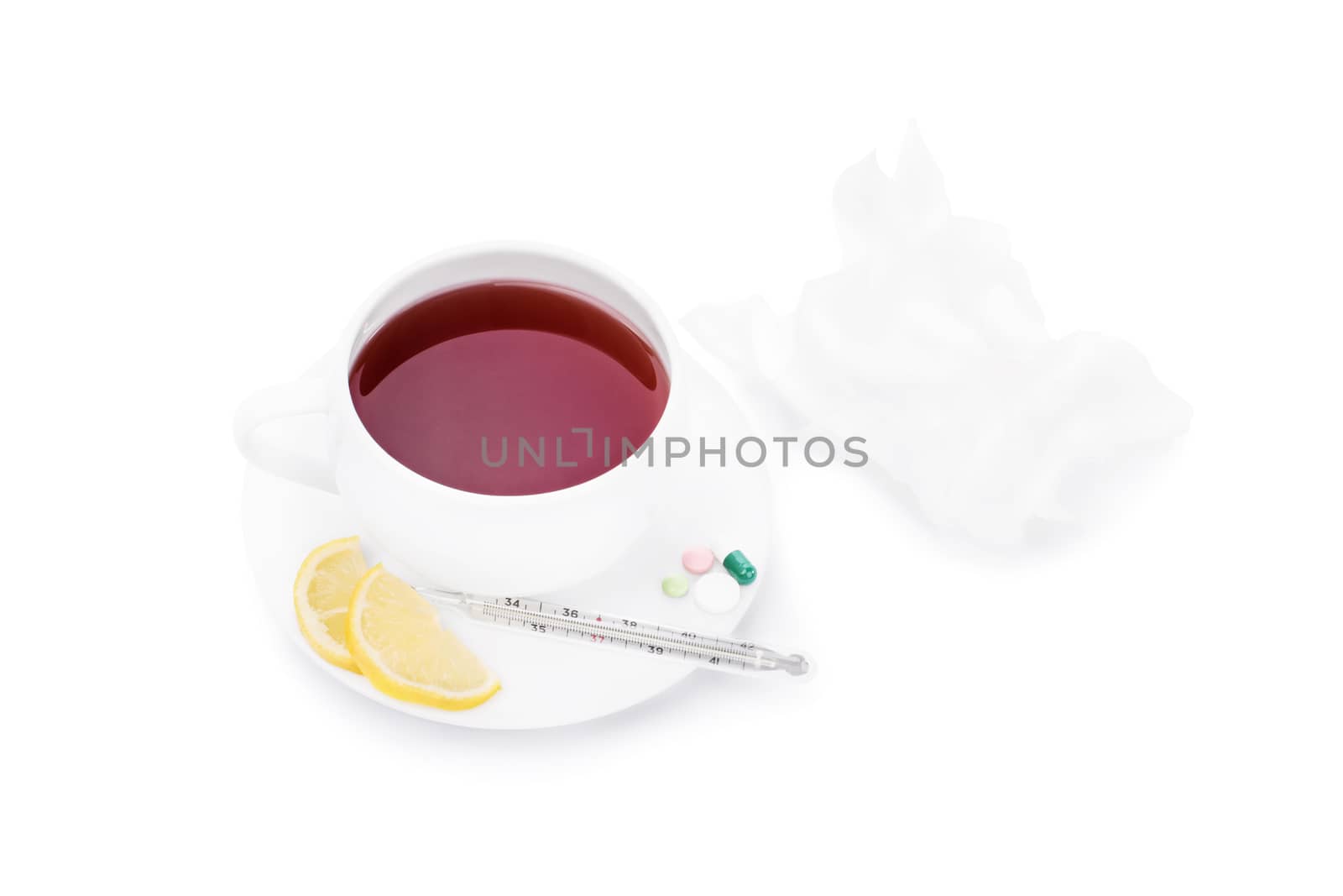 Cup of tea with pills, lemon slices, a thermometer and wrinkled tissue paper, isolated on white background.
