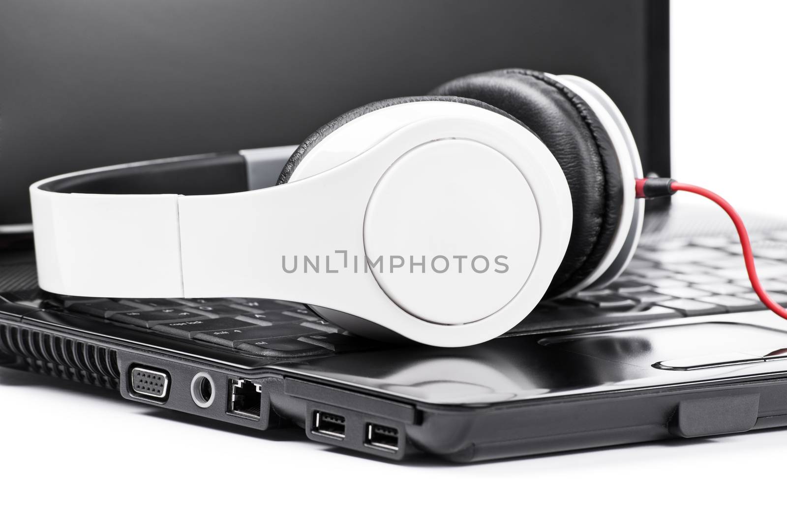 Close up shot of headphones on a laptop, isolated on white background.