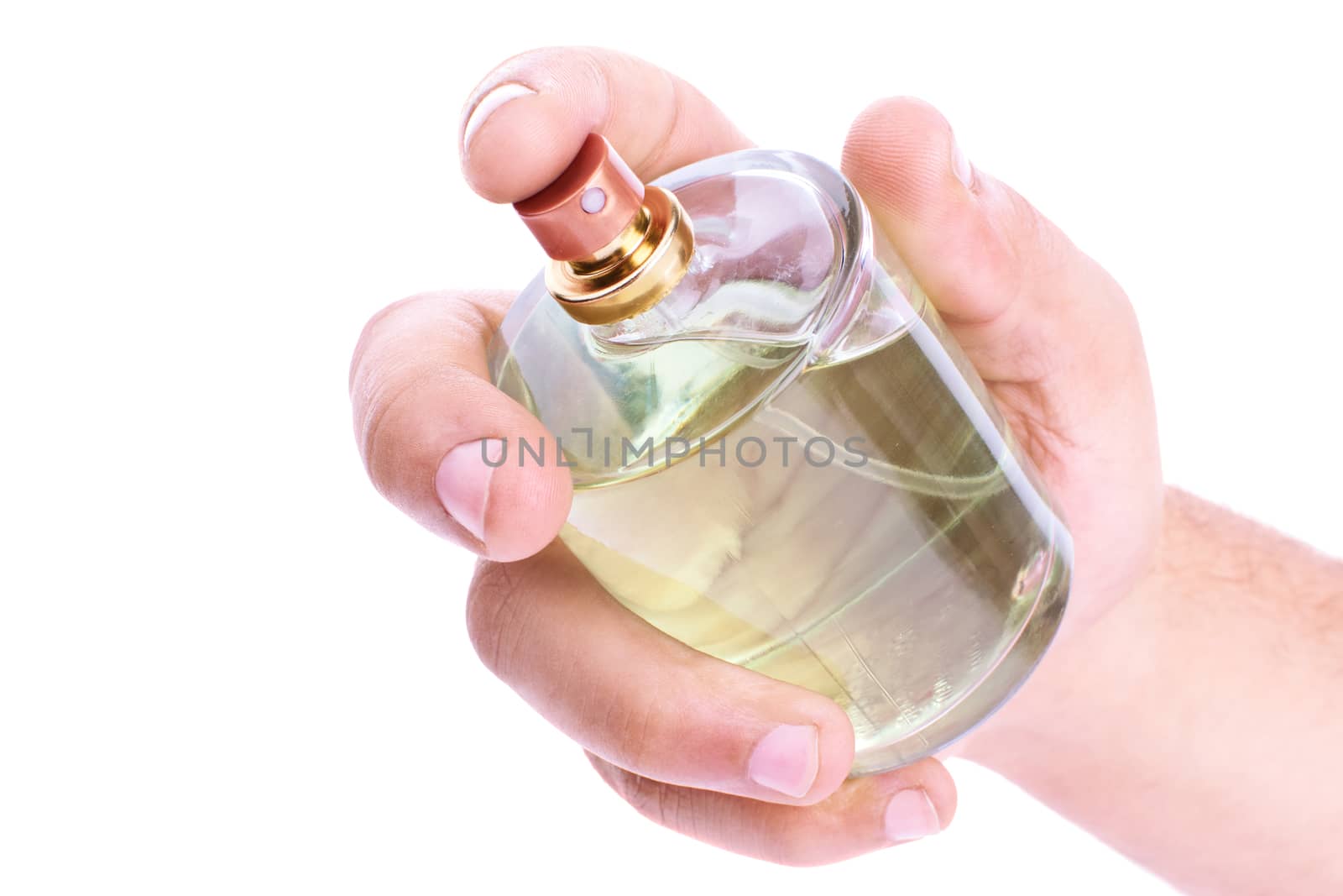Human hand holding a perfume bottle, isolated on white background.