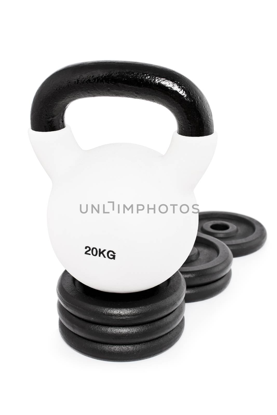 White heavy kettlebell on a pedestal of weight plates, isolated on a white background. Heavy win.

