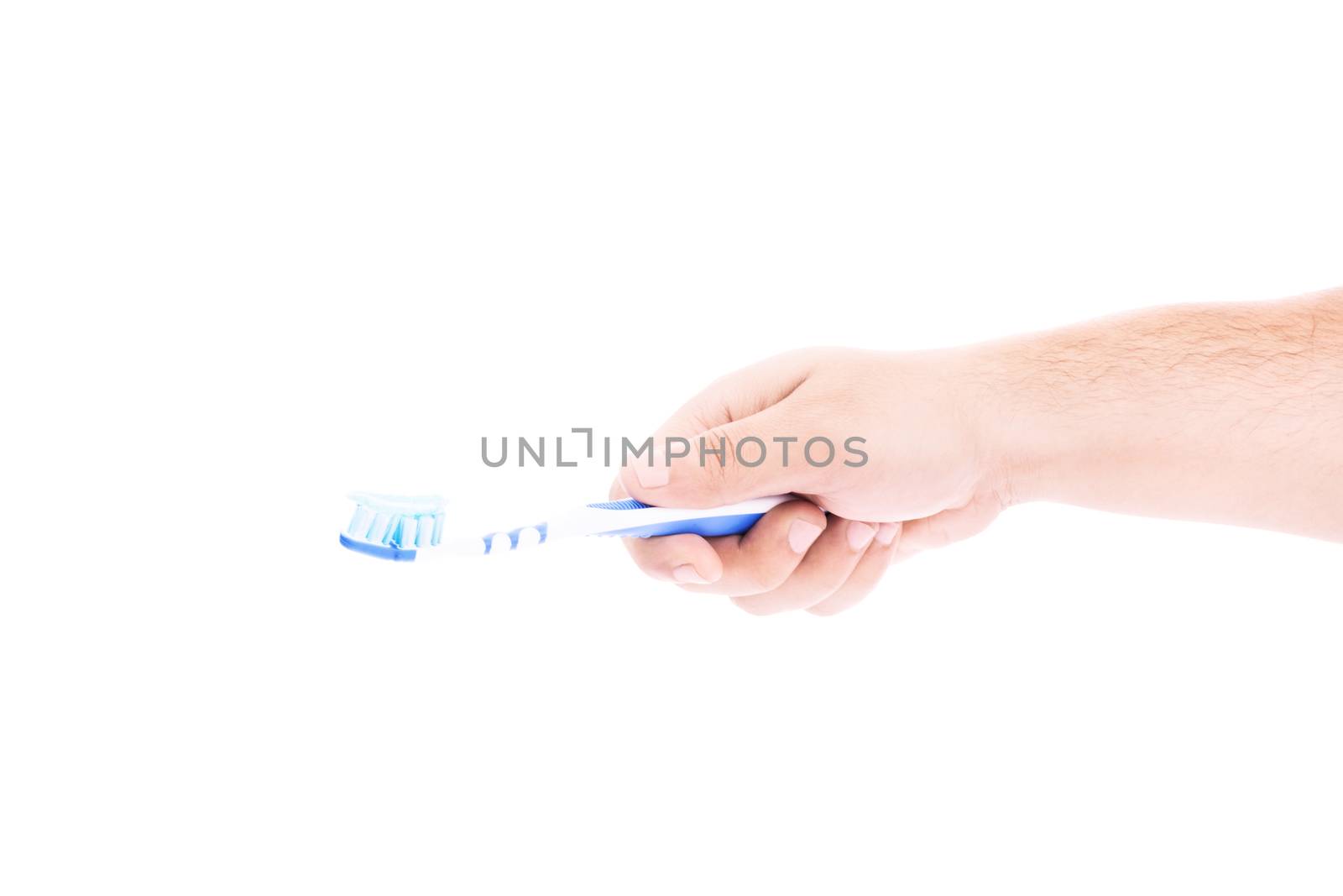 Male hand holding a toothbrush with paste by Mendelex