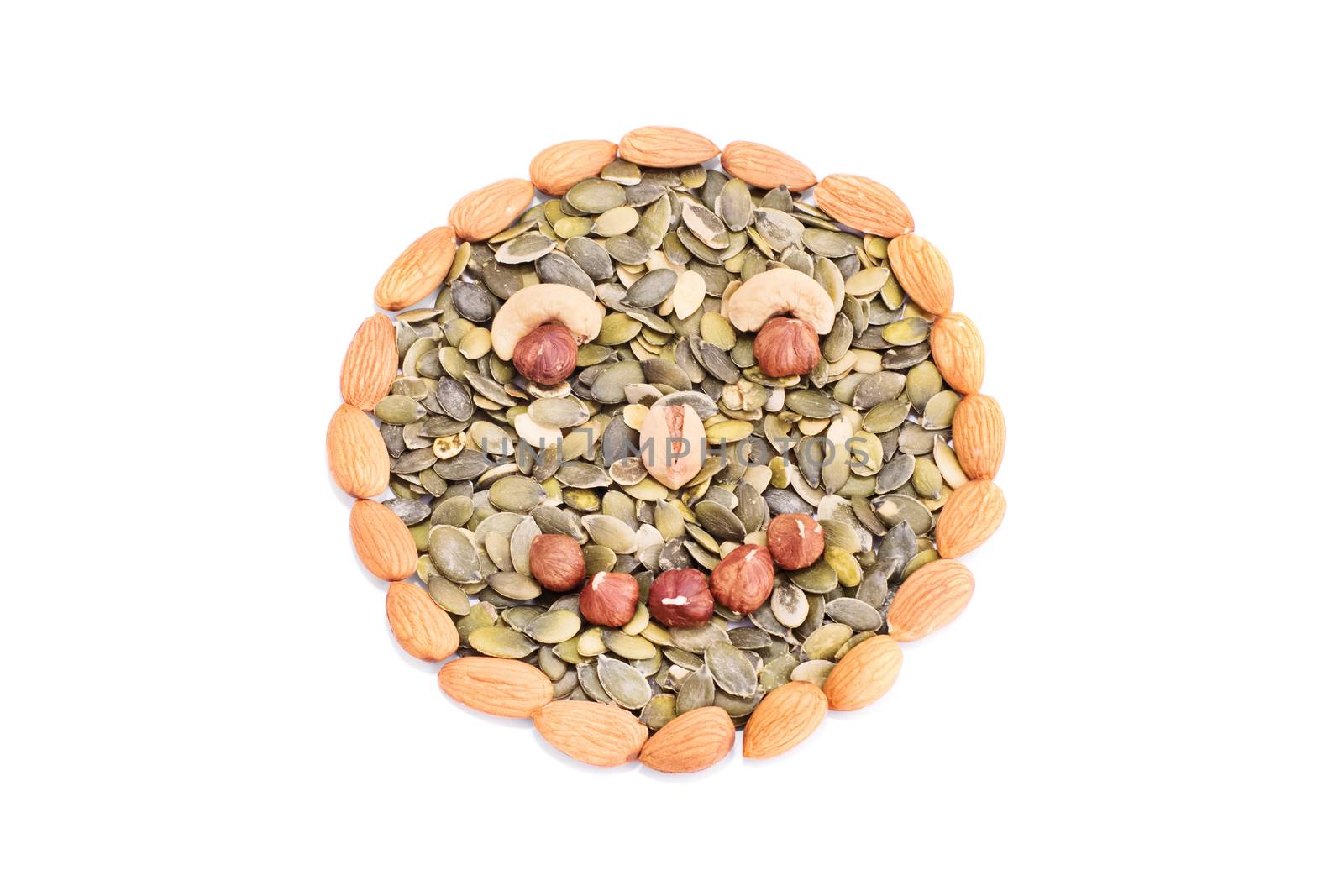 Smiley face made out of variety of nuts and seeds, isolated on white background.