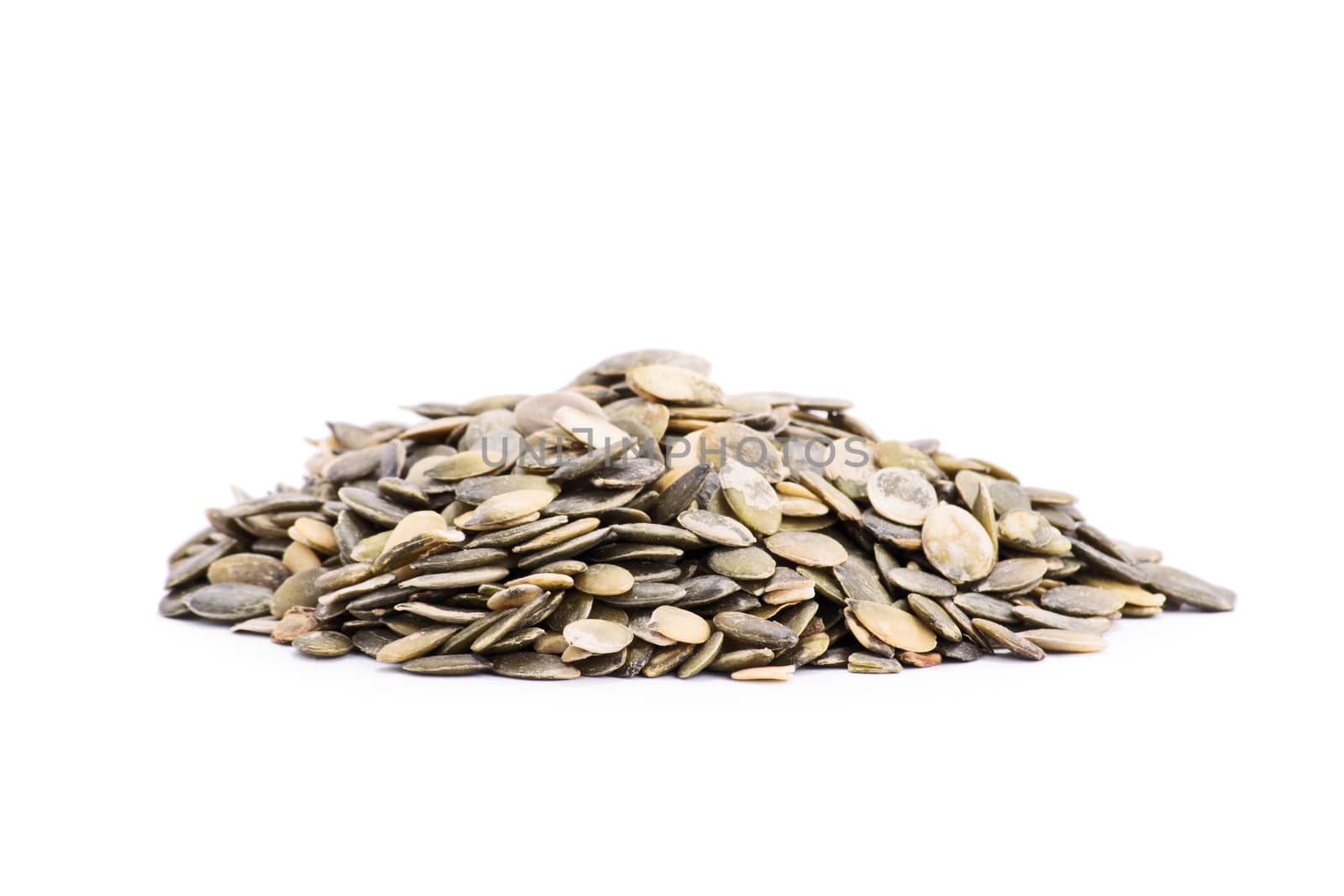 Heap of pumpkin seeds isolated on white background.